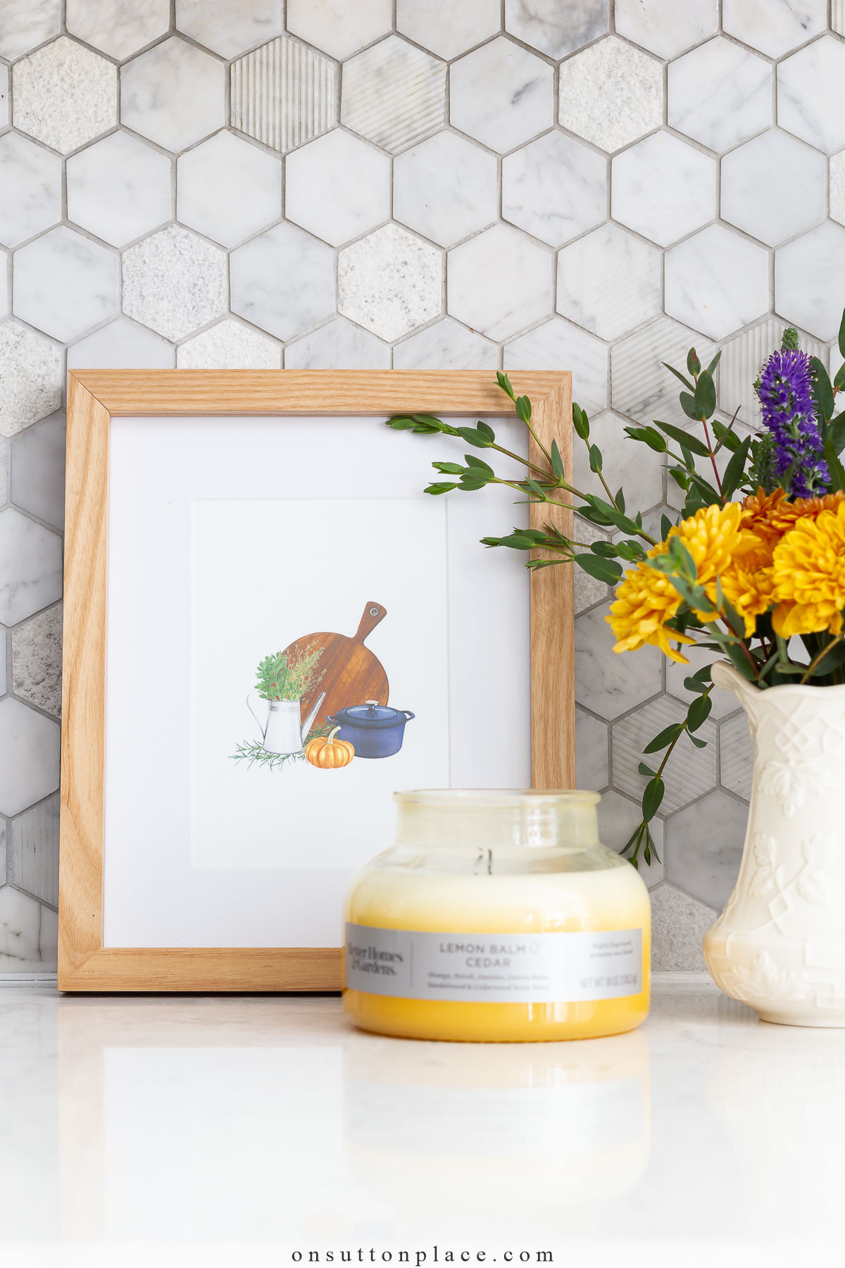 free fall printable in frame on kitchen counter with flowers and candle