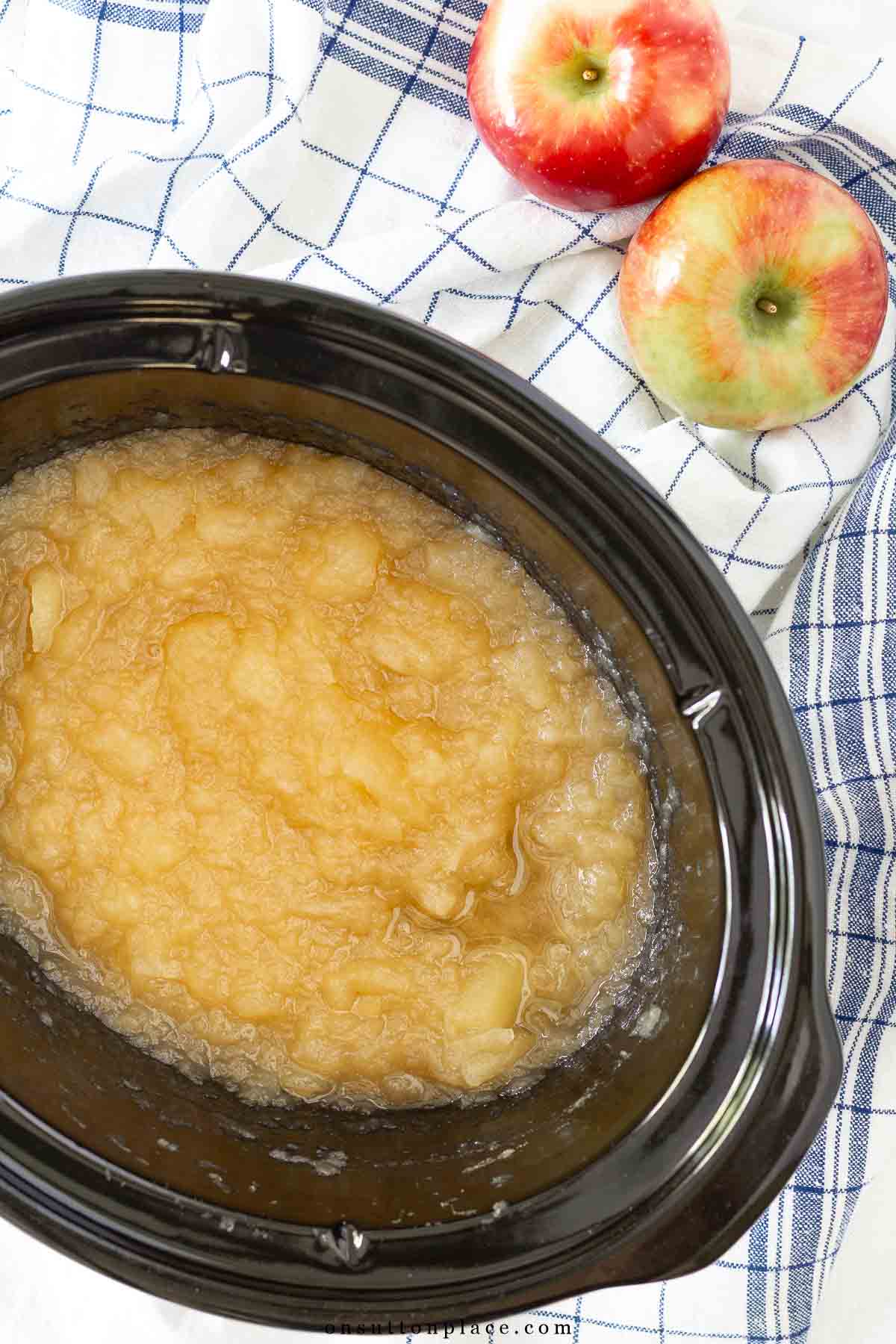 small batch crockpot applesauce with apples on the side blue and white towels