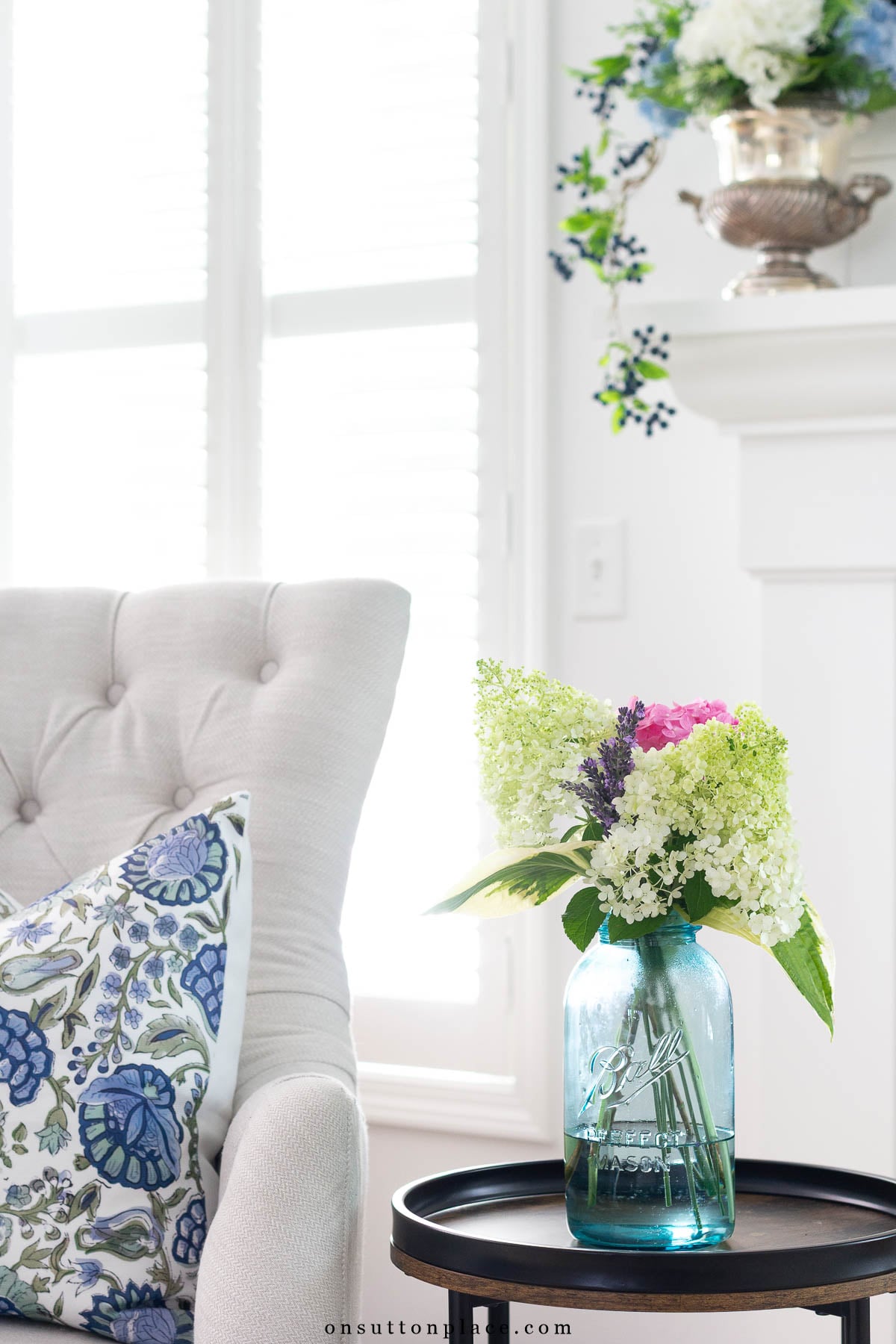 living room corner tufted chair with pillow mason jar with flowers on round table
