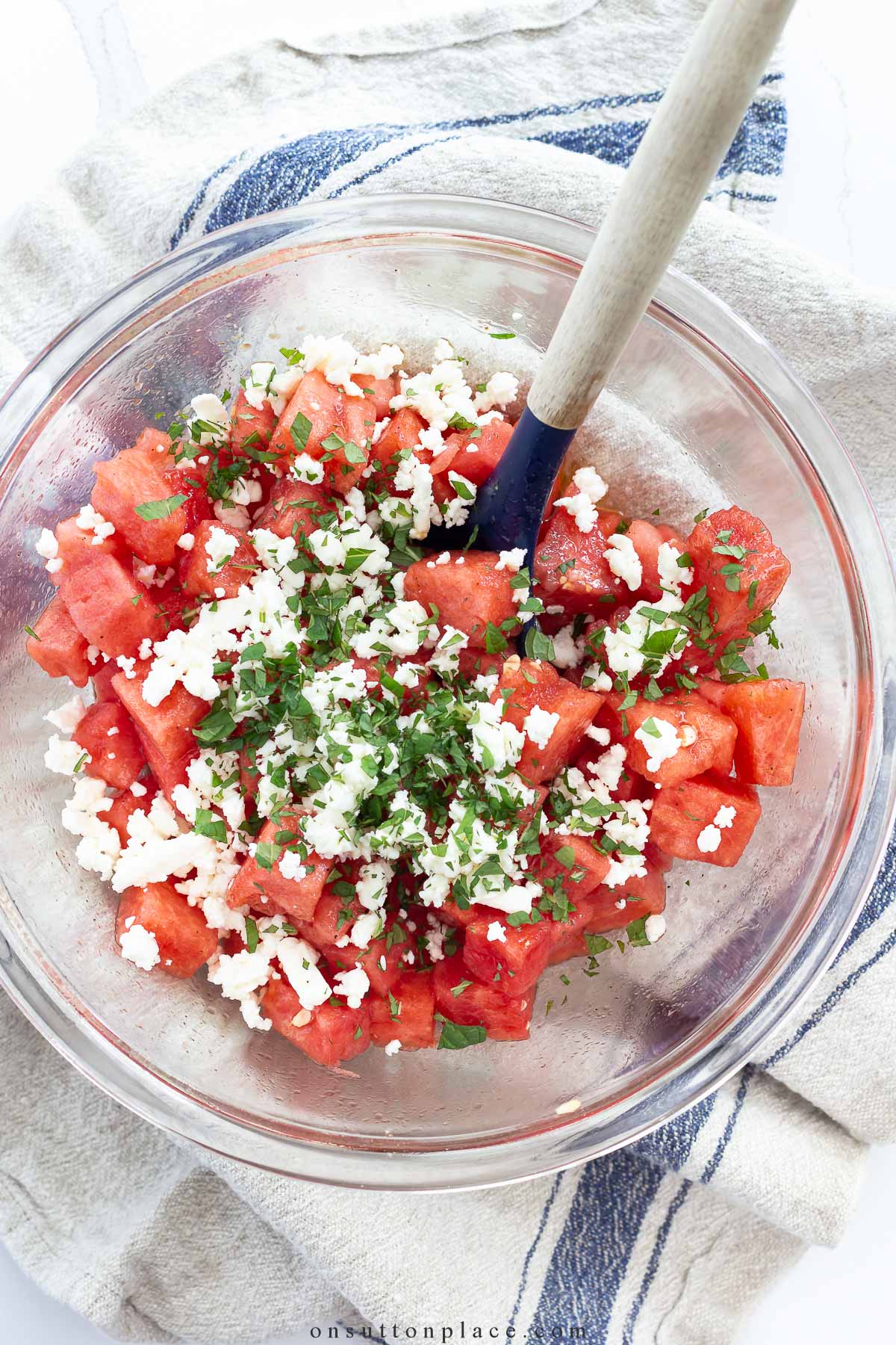 watermelon with mint and feta in serving bowl with spoon