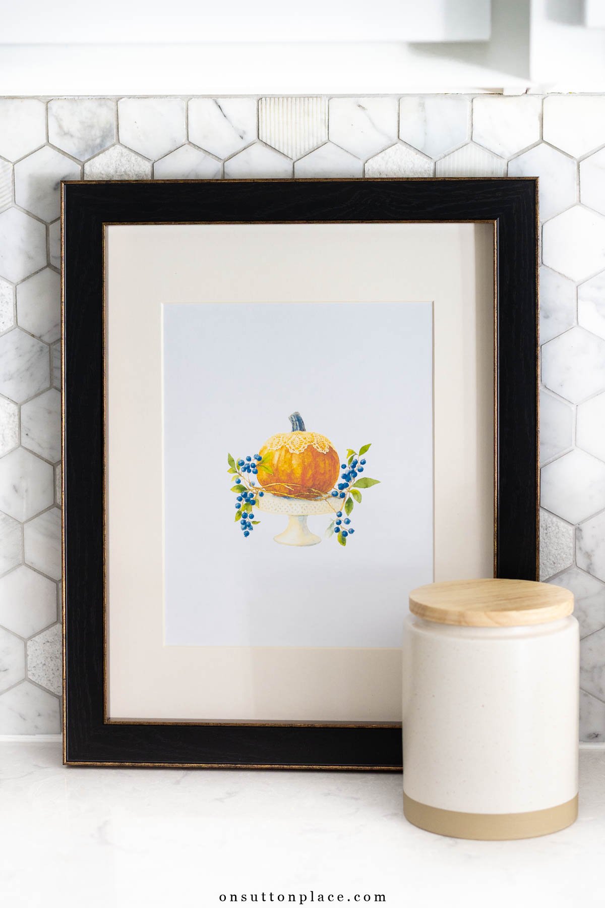free fall printable wall art pumpkin in frame on kitchen counter