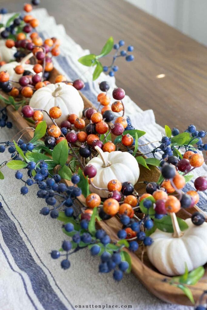 faux blueberries and autumn berries in dough bowl fall centerpiece