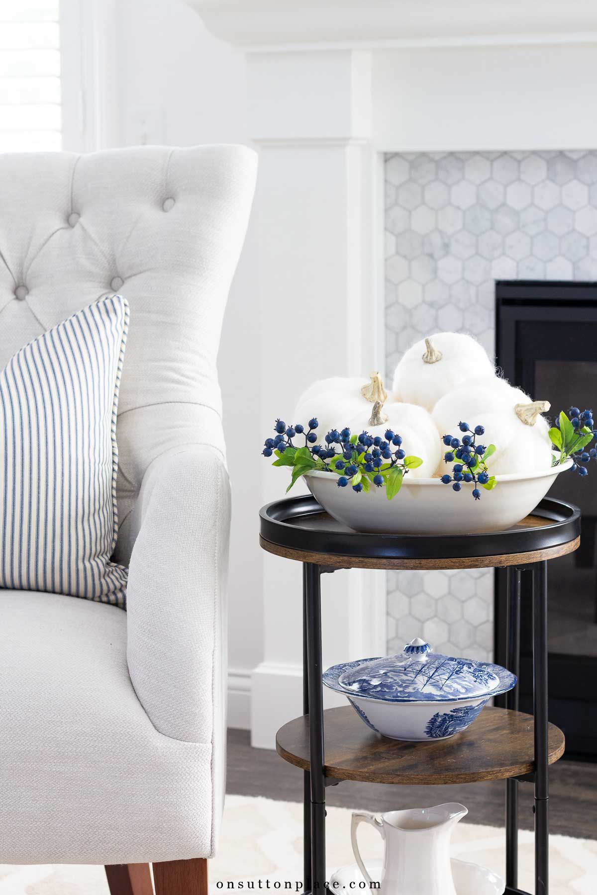 faux pumpkins in bowl on round side table halloween decor