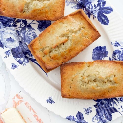 loaves of homemade banana bread recipe on blue floral platter