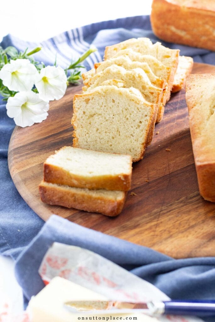 sliced loaf of banana bread on round wood board 2025