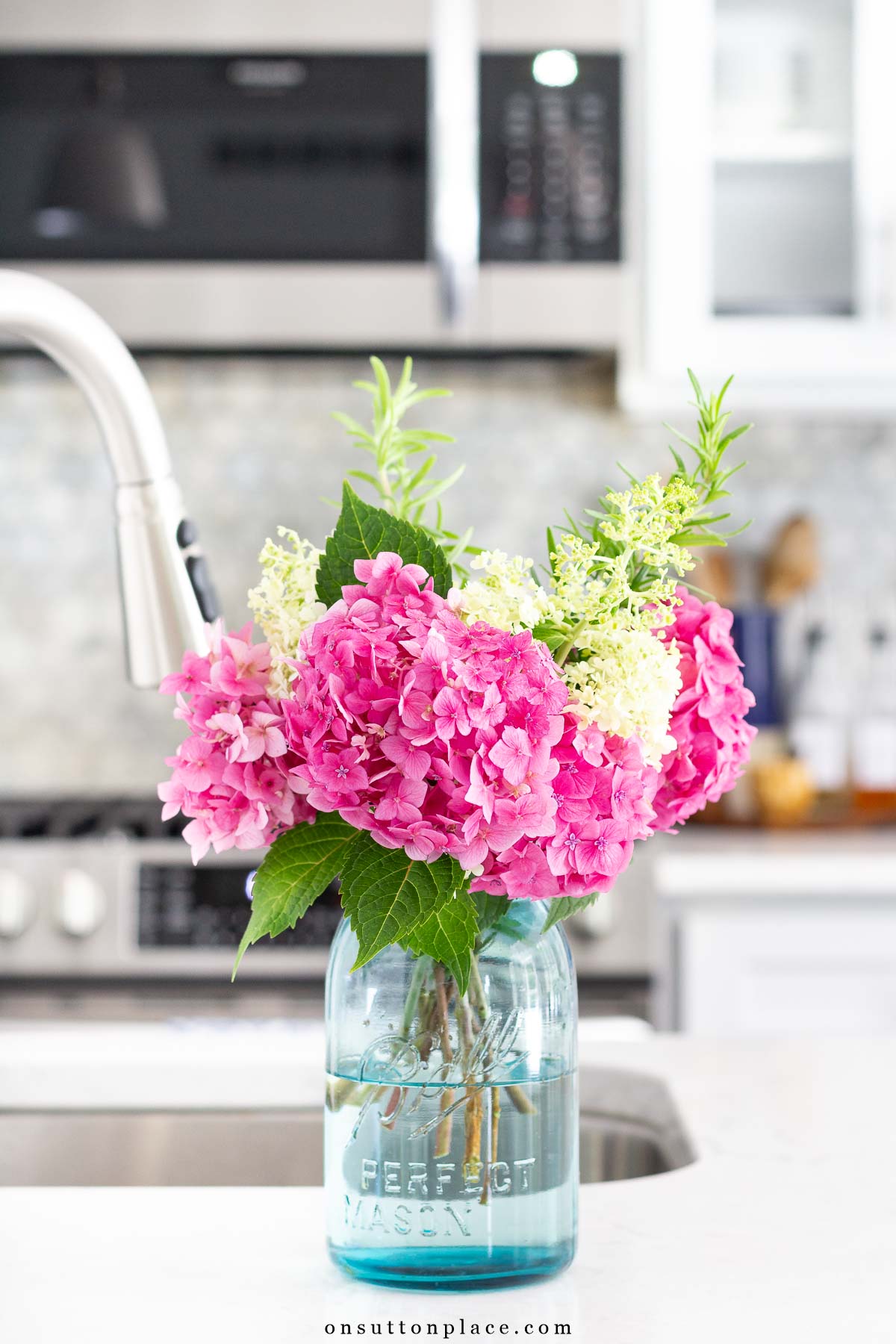 garden hydrangeas in blue ball jar on kitchen counter