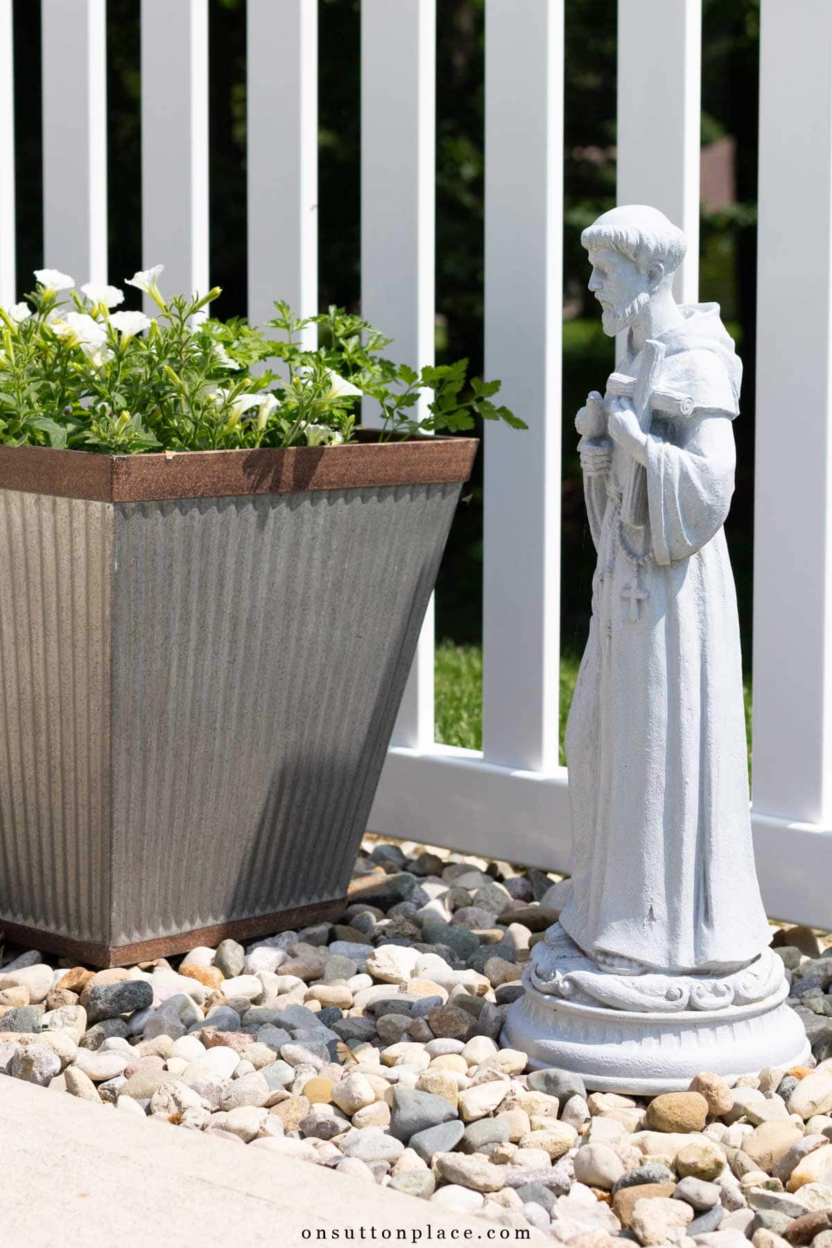 st. Francis garden statue beside planter