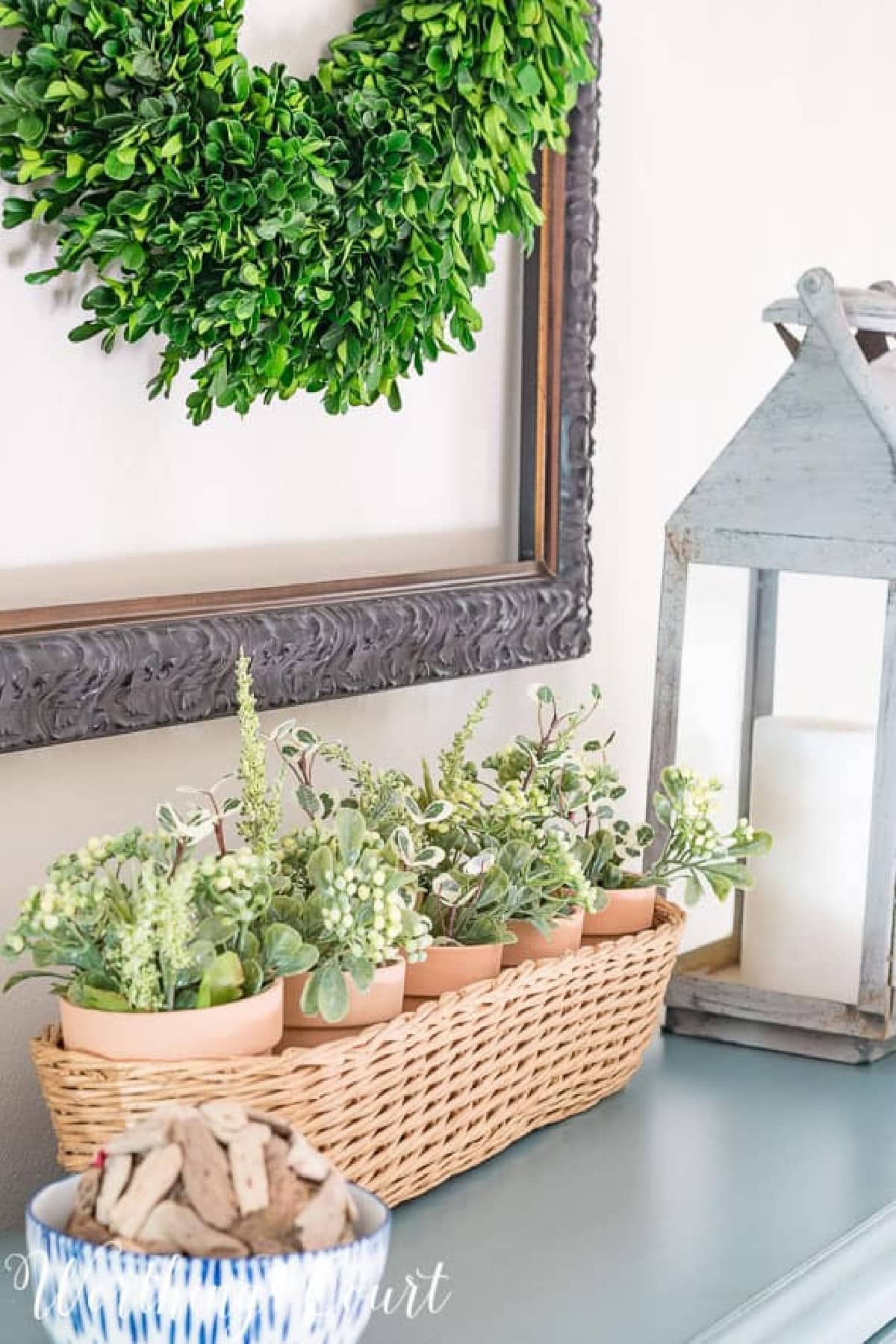 vignette with basket of plants and lantern worthing court hss
