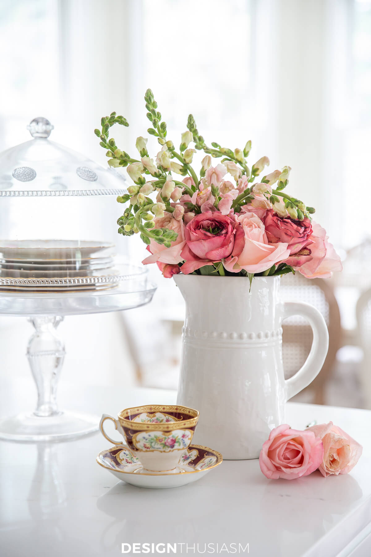white pitcher with pink flower arrangement on kitchen counter designthusiasm hss