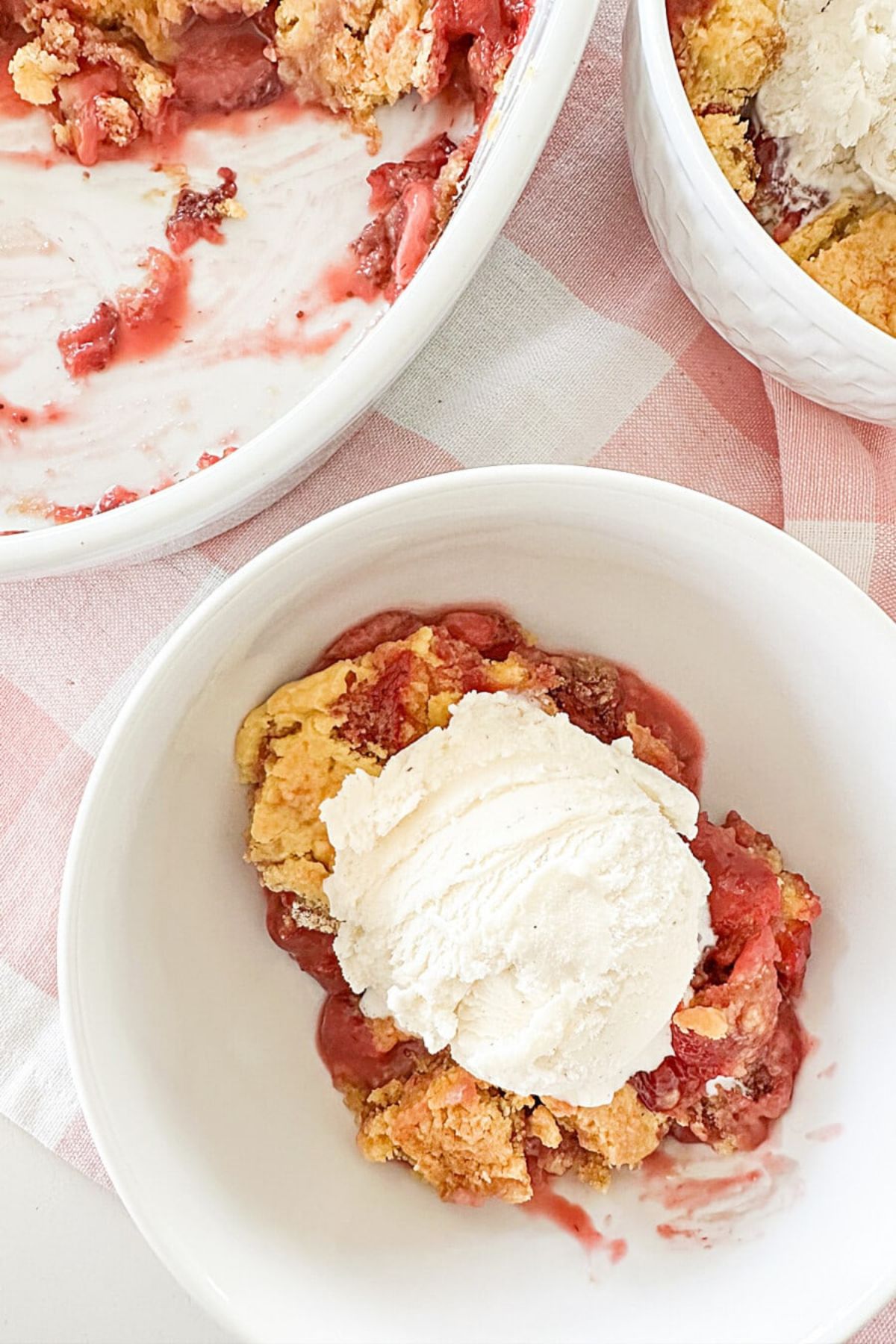 strawberry cobbler in a bowl with ice cream stonegable hss