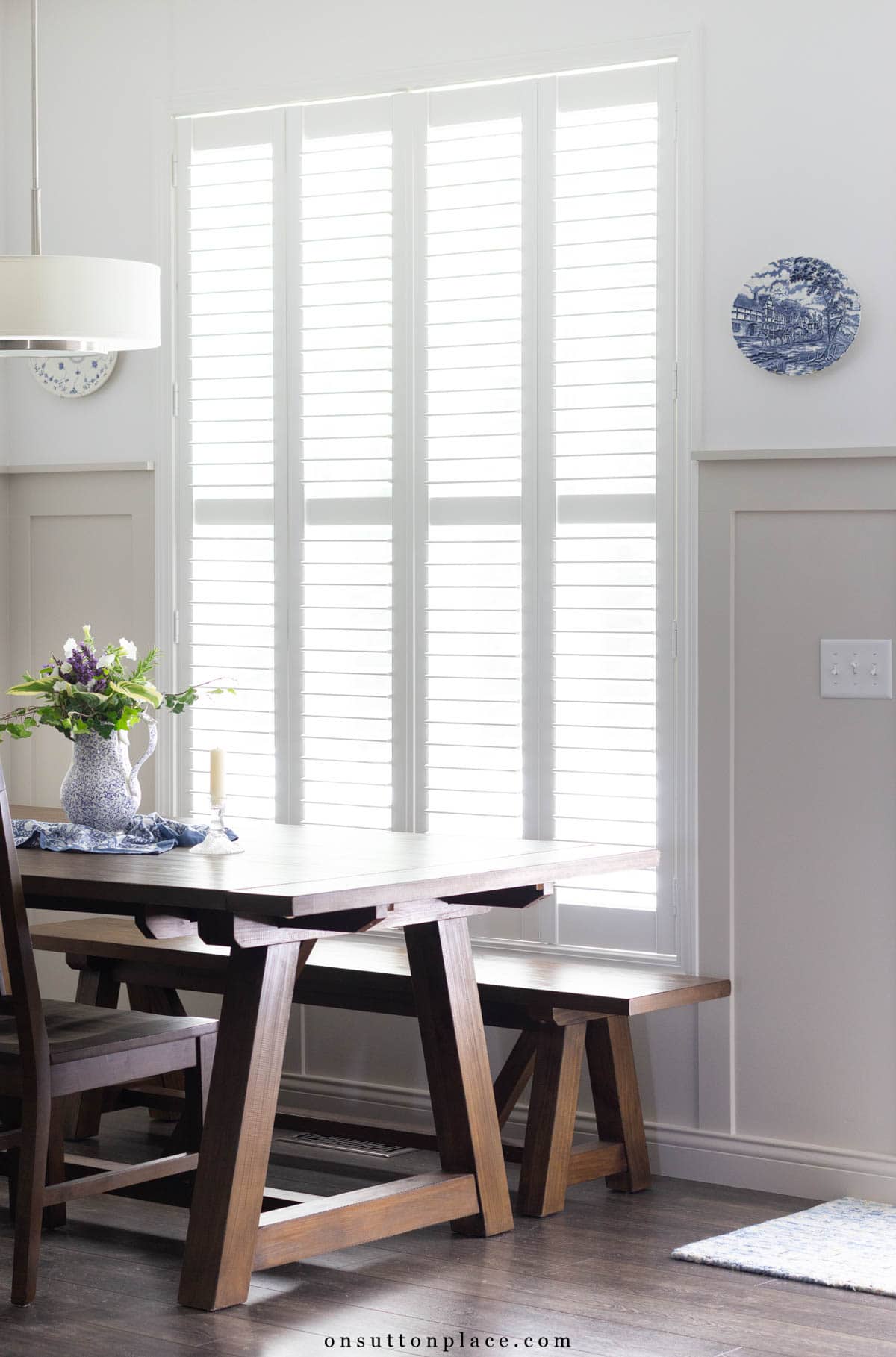 dining nook with large window and farmhouse table