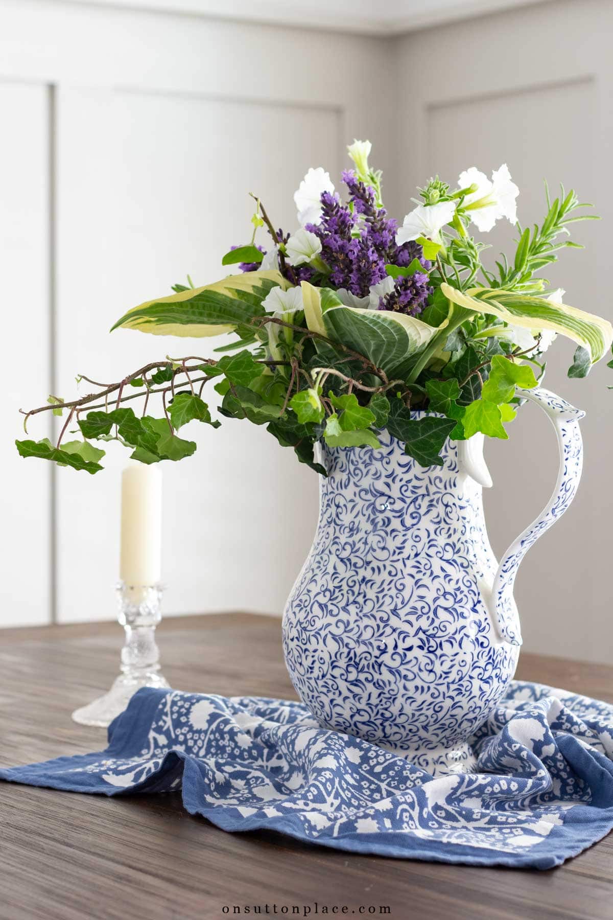 garden flower arrangement in pitcher on table