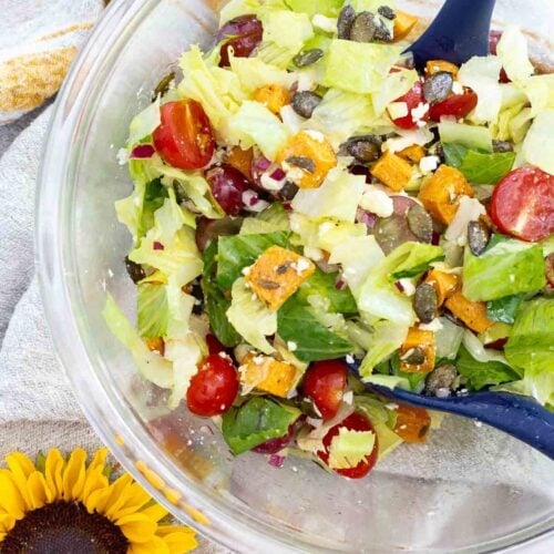 autumn romaine lettuce salad in large bowl with sunflower