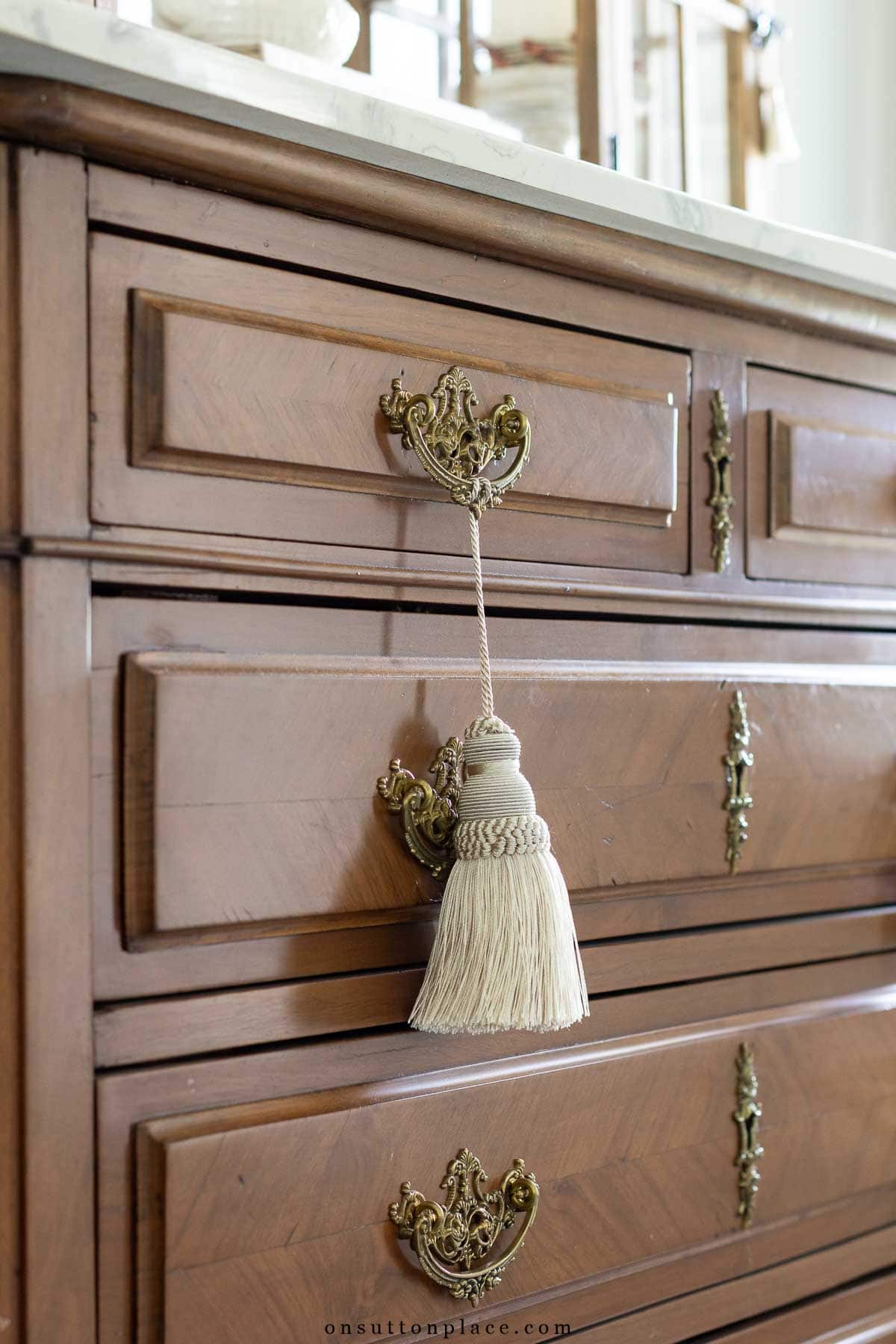 ivory tassel hanging from dresser handle