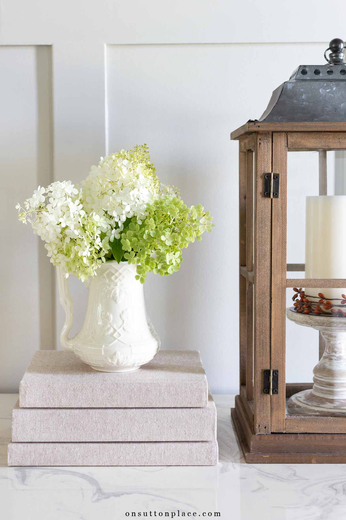 stack of books with pitcher of dried hydrangeas foyer decorating ideas