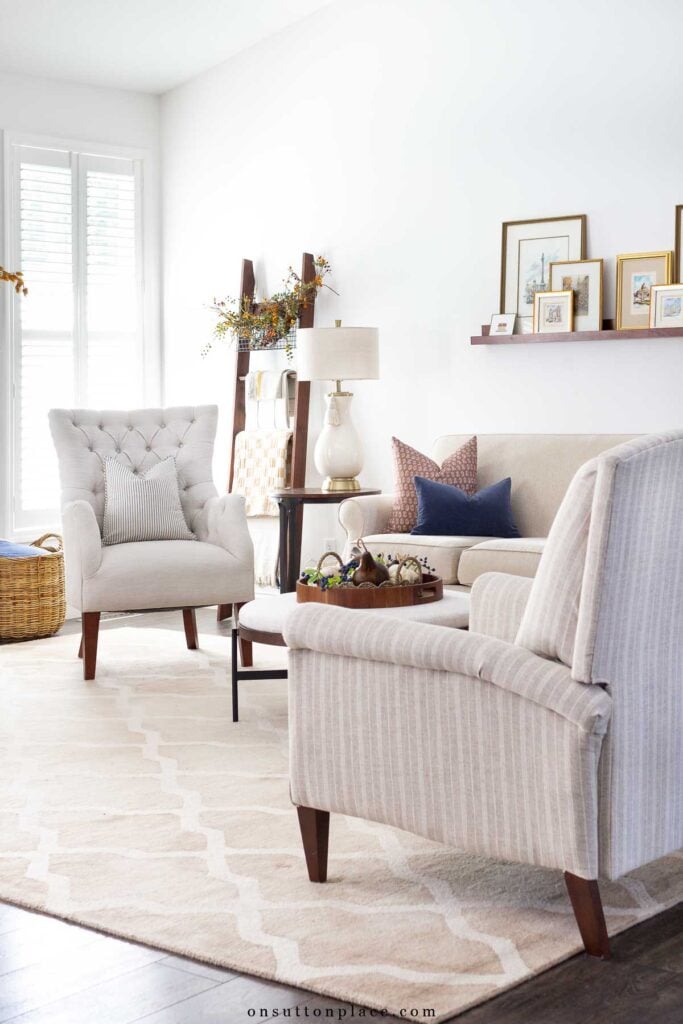 cozy living room decorated for fall with blue and gold accents