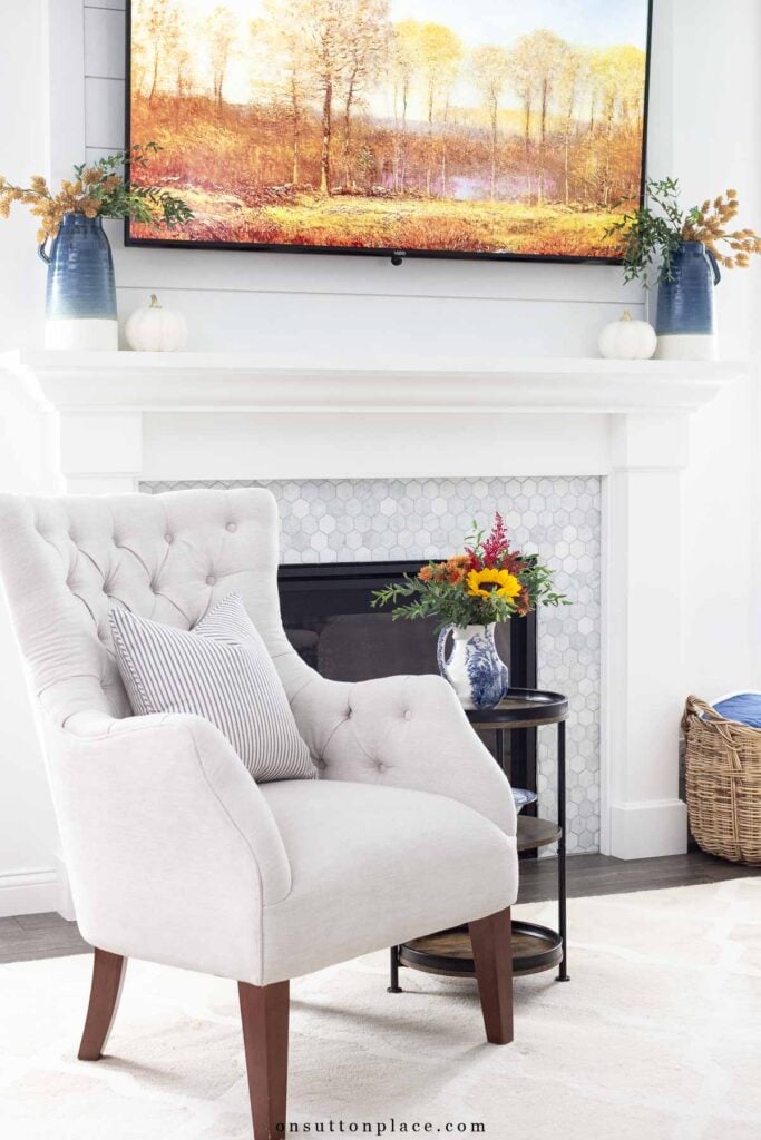 cozy living room mantel decorated with blue and earthy autumn colors fall screensaver on tv
