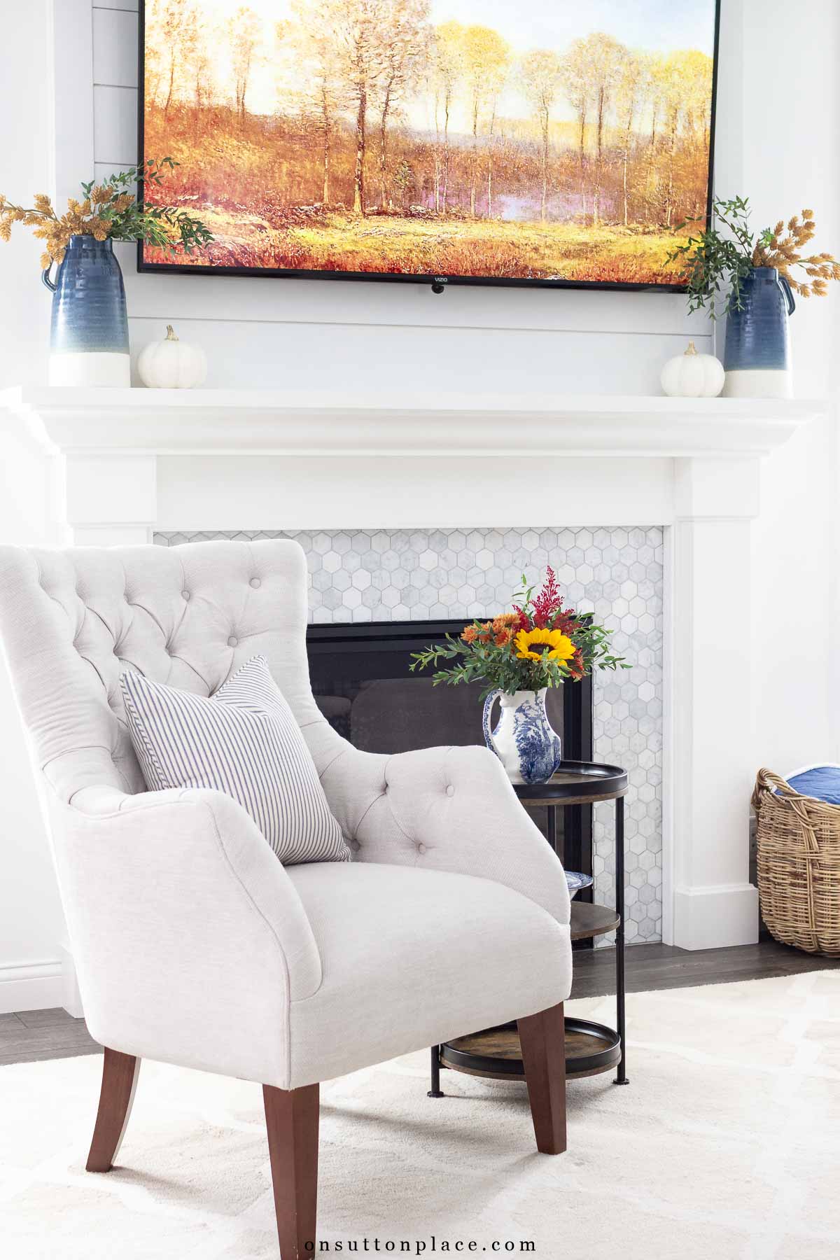 cozy living room mantel decorated with blue and earthy autumn colors fall screensaver on tv