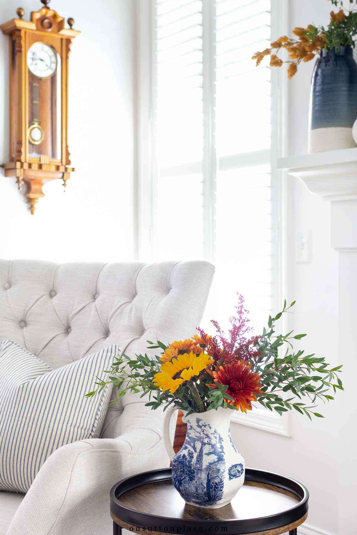 fall flowers in simple blue and white pitcher on living room table