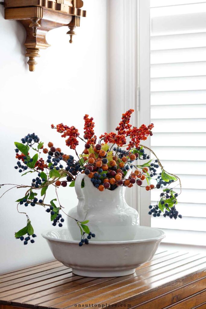 vintage pitcher and bowl on blanket chest fall floral arrangement