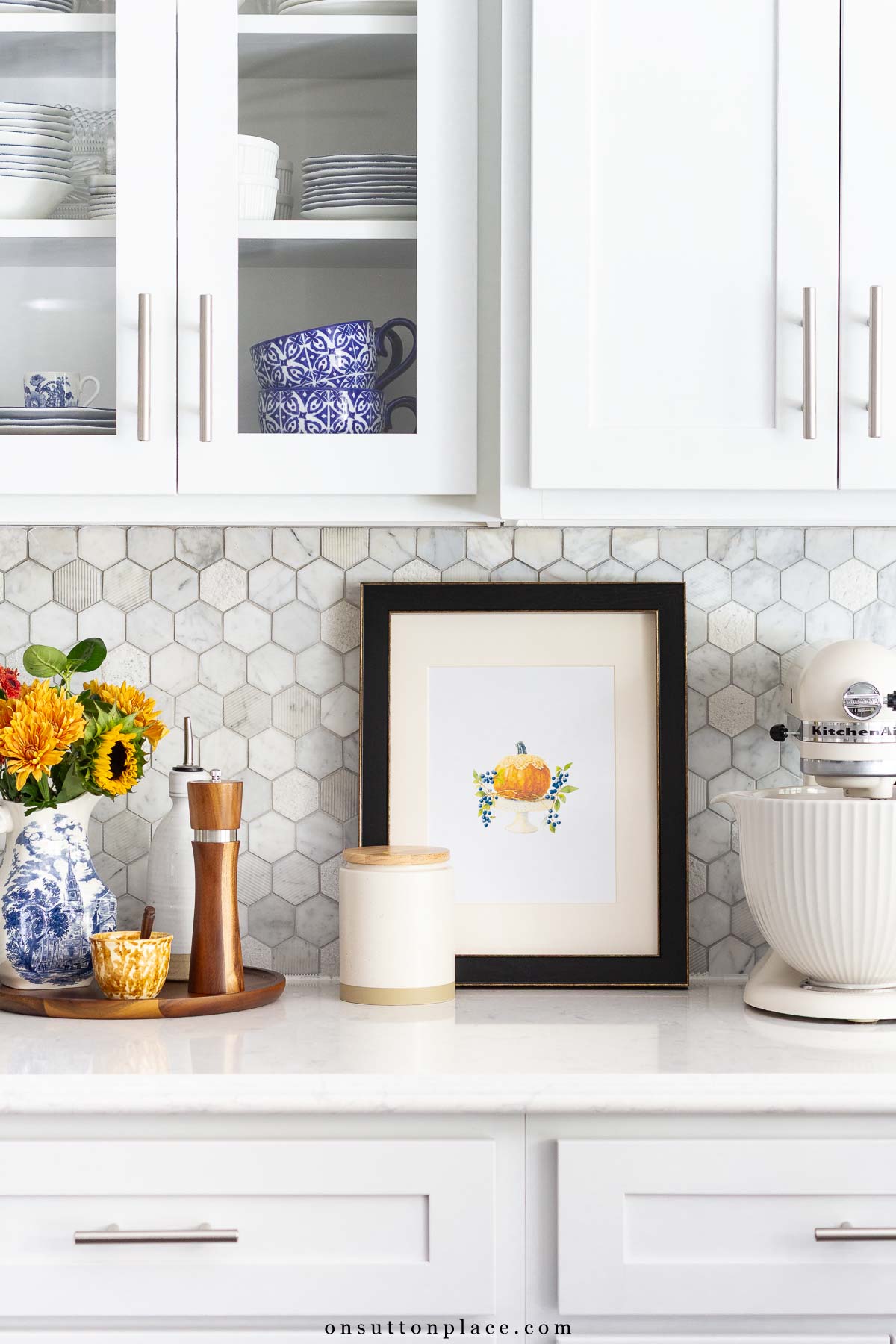 white kitchen with fall accents framed print and pitcher of flowers