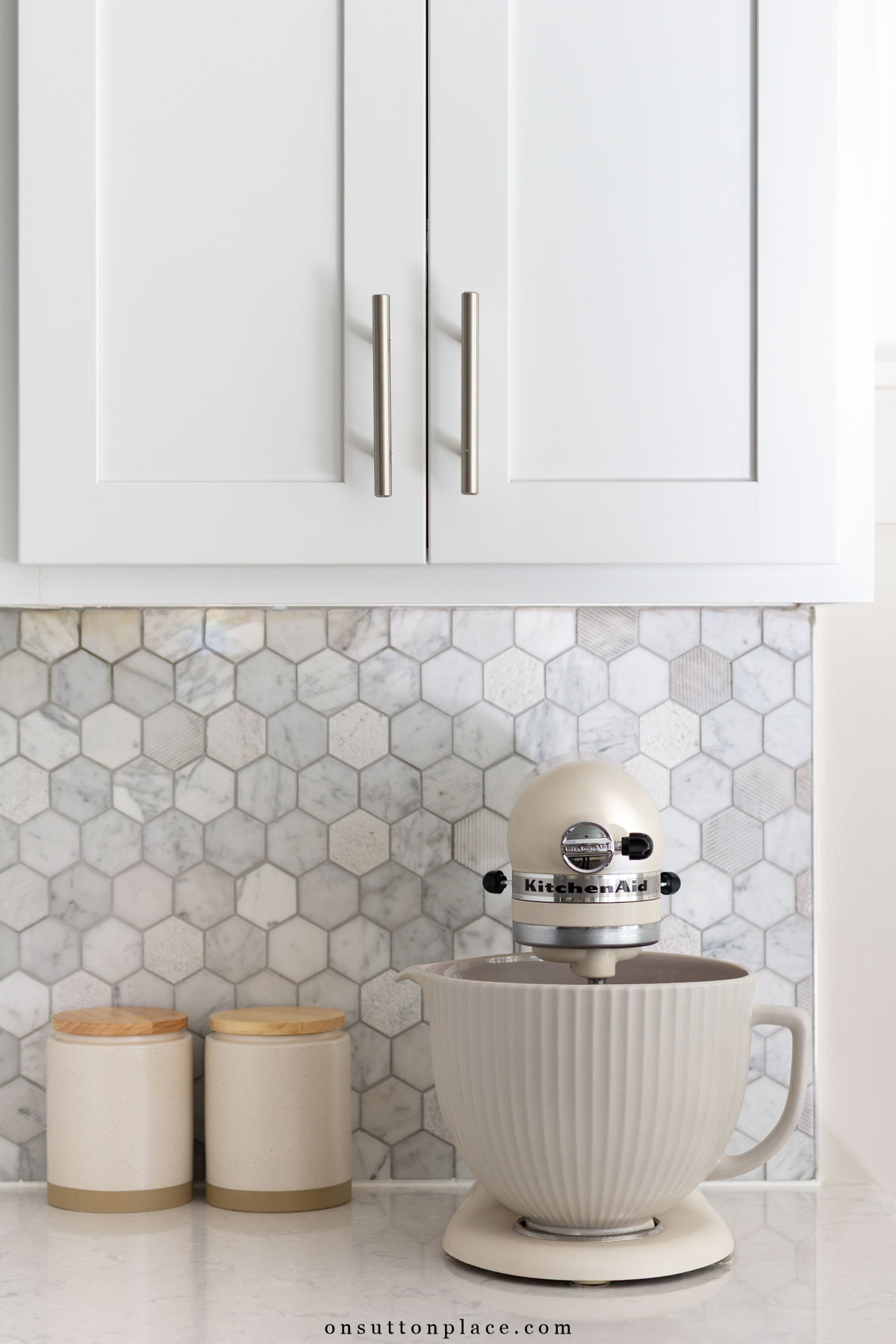KitchenAid mixer on kitchen counter gray hexagon tile backsplash
