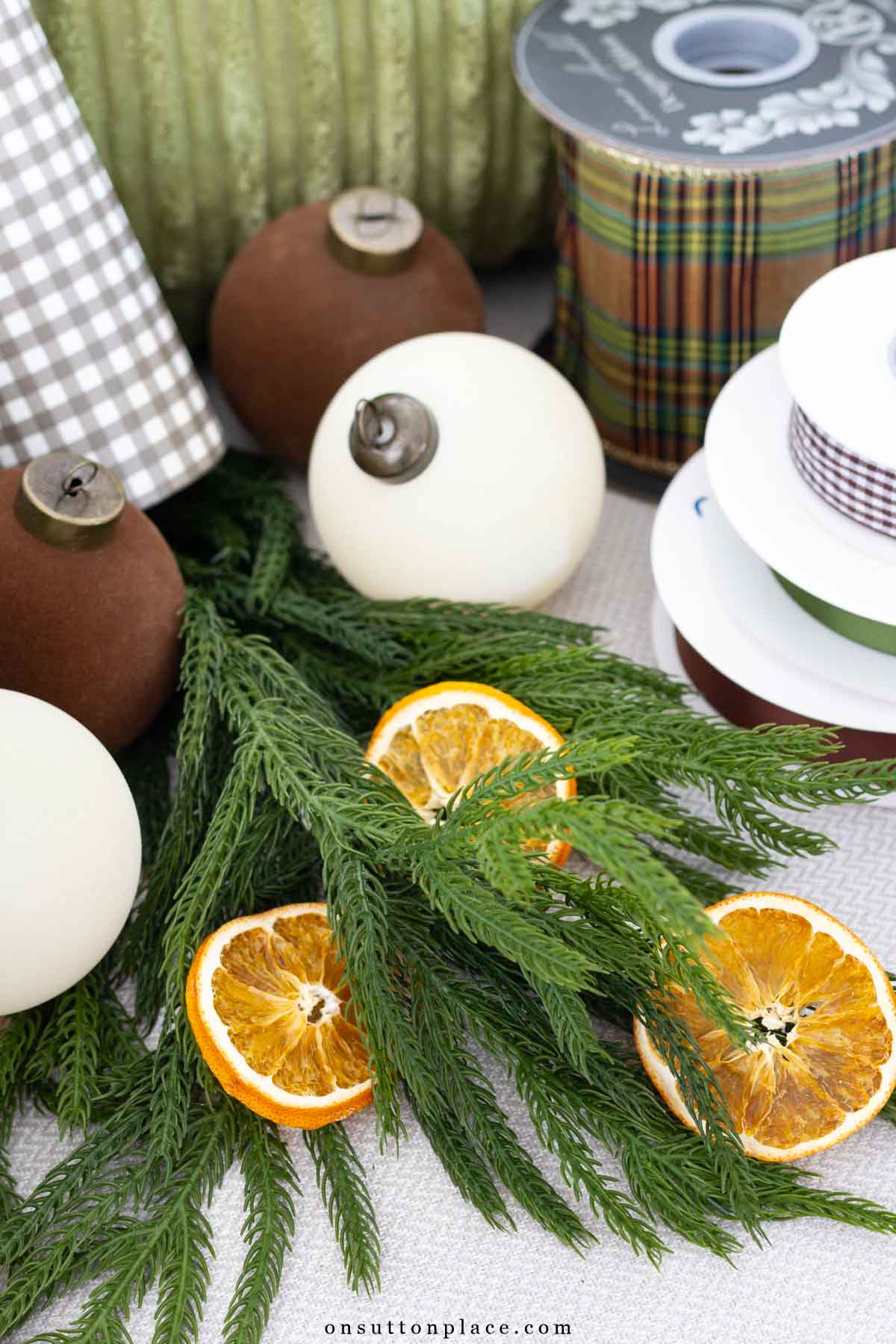 Christmas decor ideas norfolk pine dried orange slices ornaments ribbon