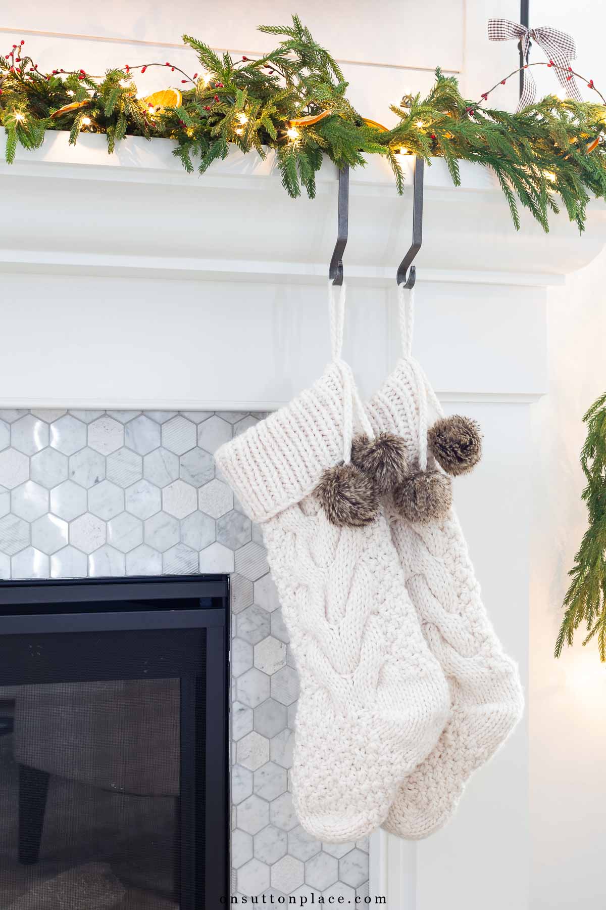 Christmas decor knit stockings hanging on neutral mantel