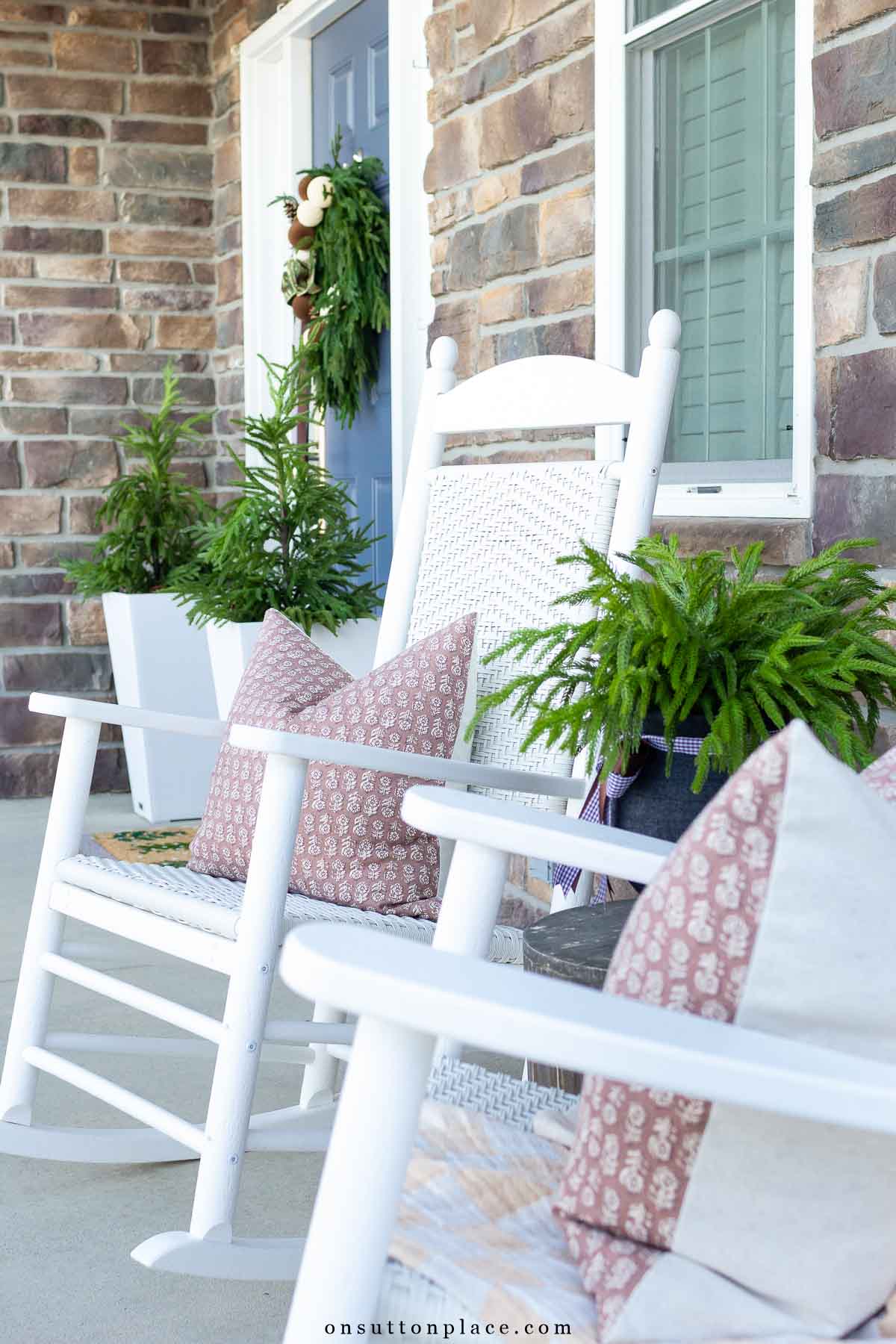 Christmas porch with neutral decor Norfolk pine greenery