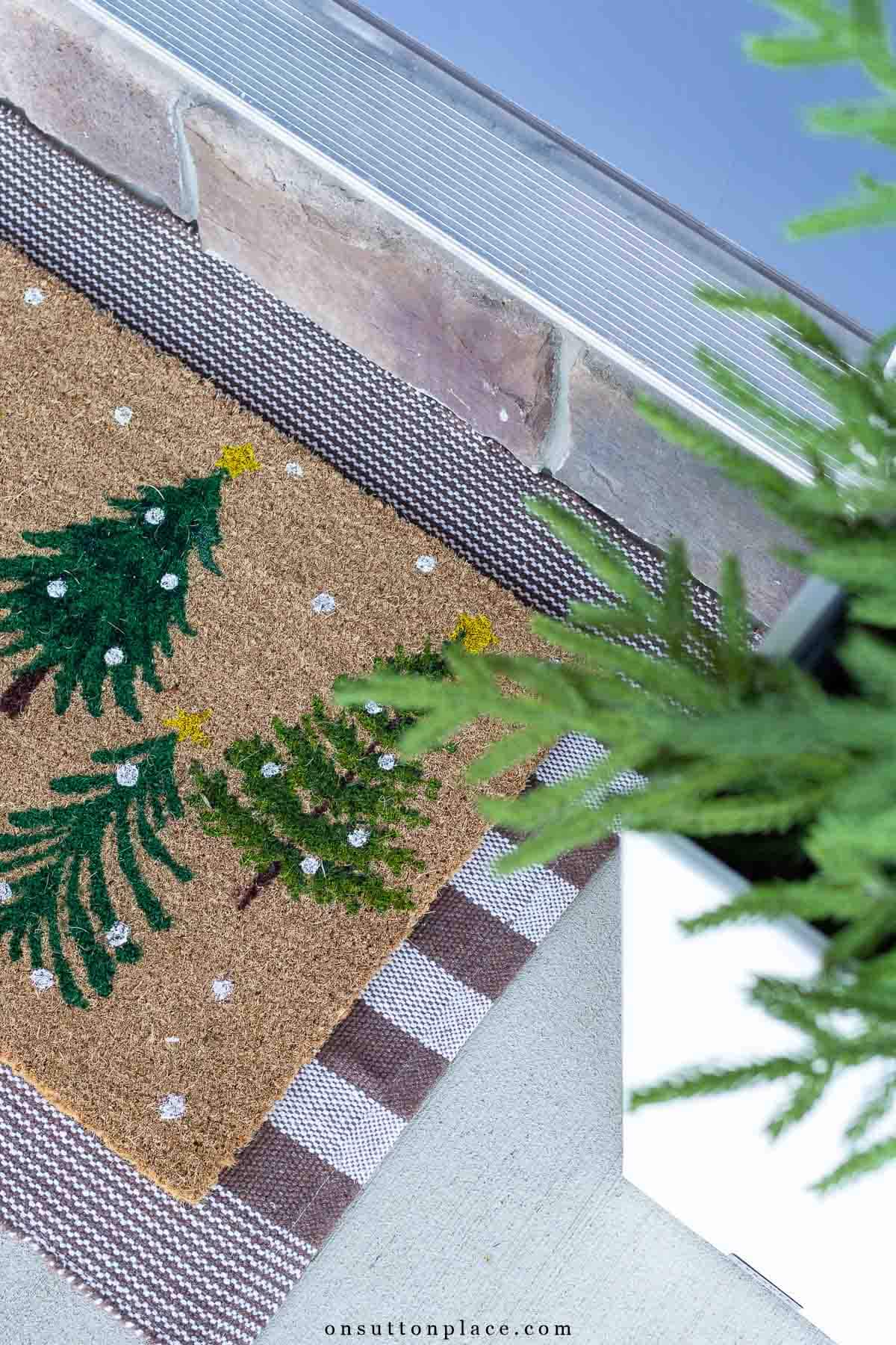 Christmas trees on coir doormat over brown striped rug