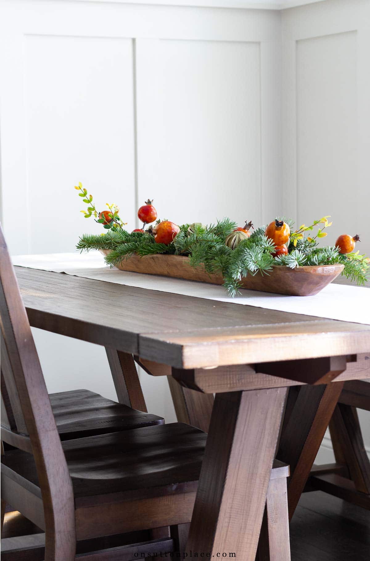 dining table with Christmas centerpiece in long dough bowl