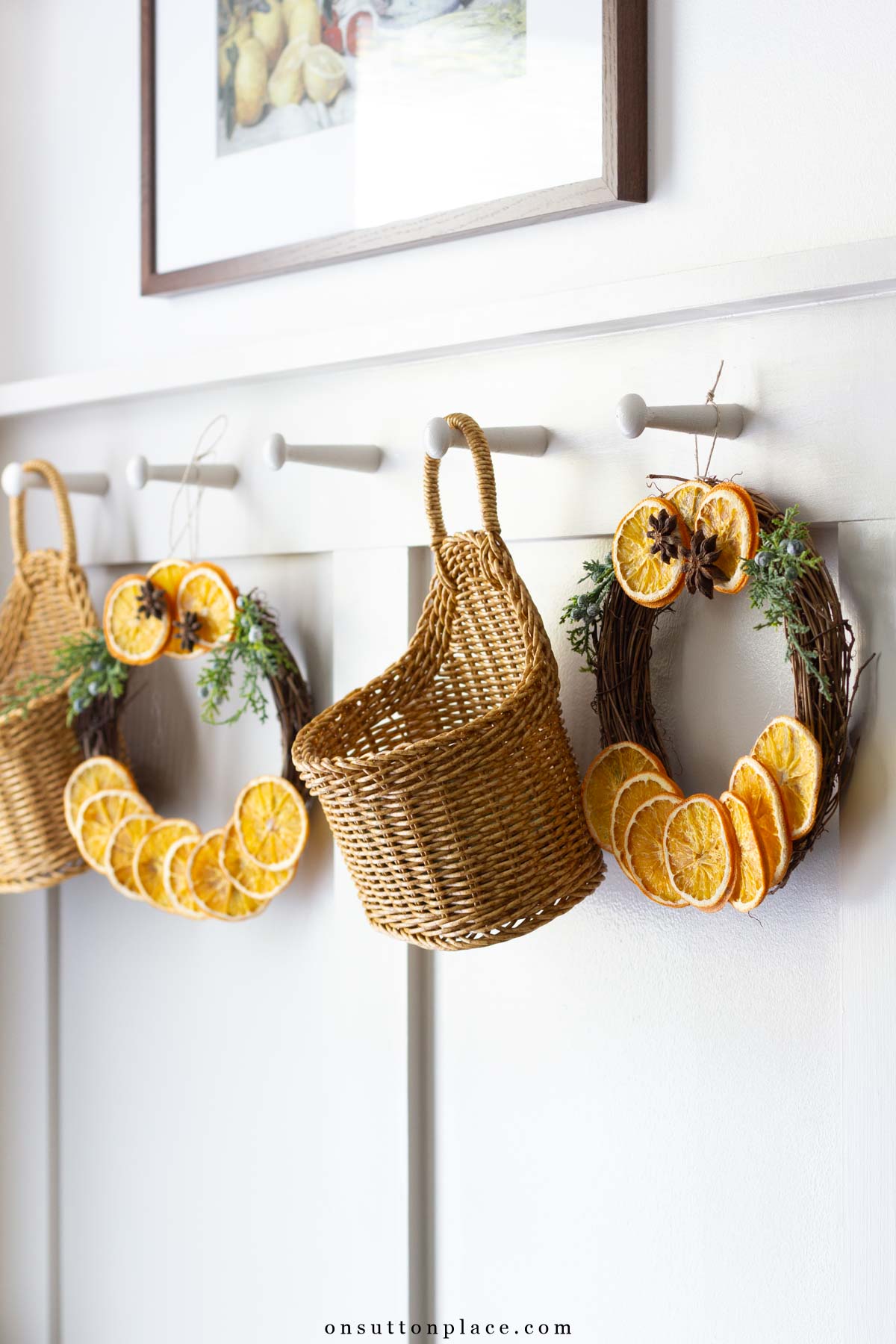 dried orange slice wreaths on shaker pegs with baskets