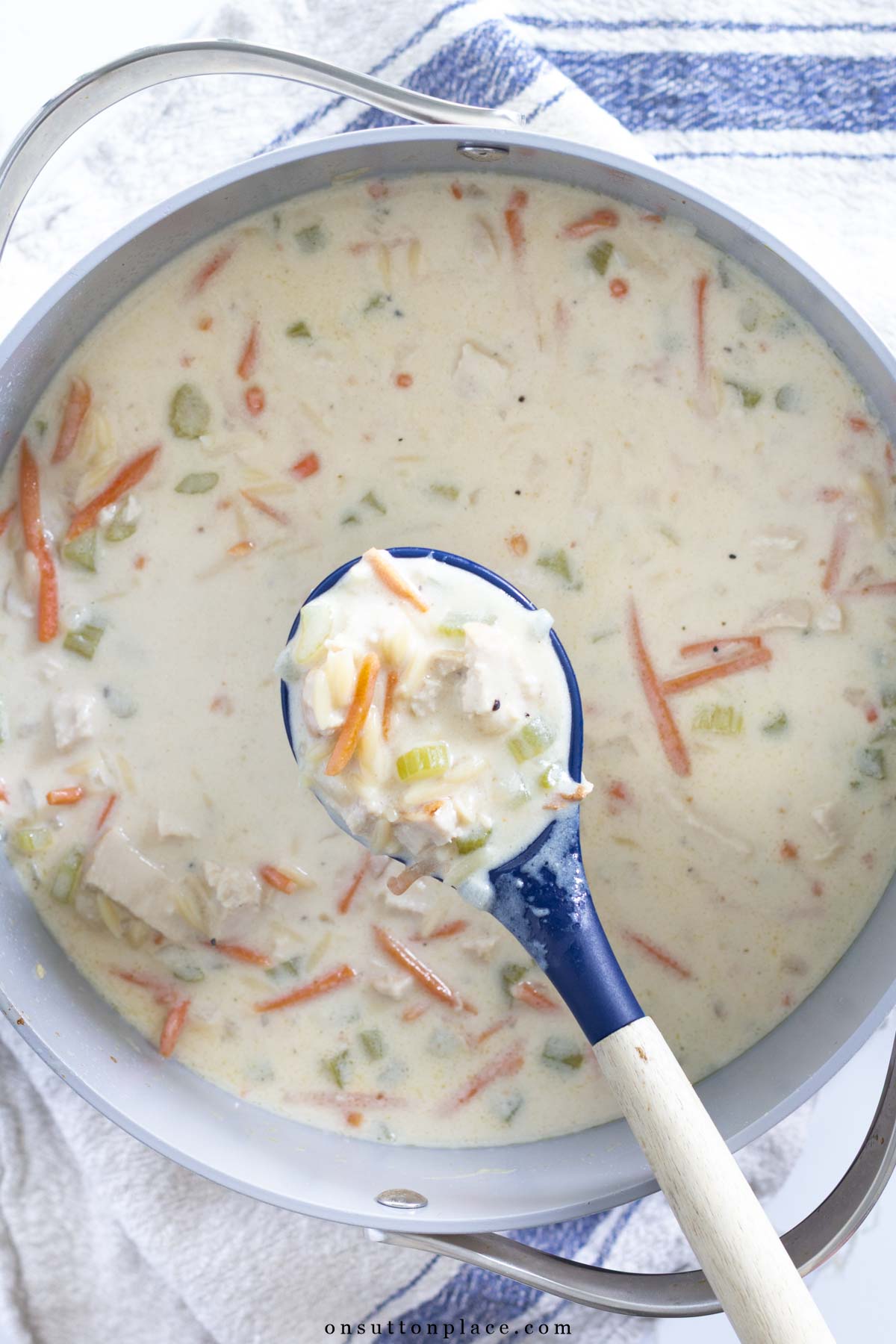 lemon chicken orzo soup in pot with spoon