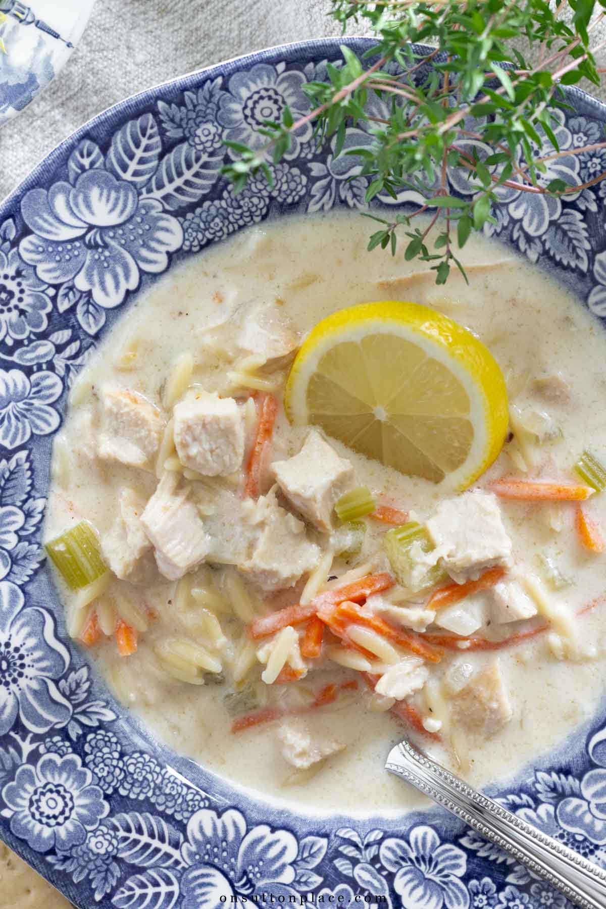 lemon chicken orzo soup recipe in bowl with thyme garnish