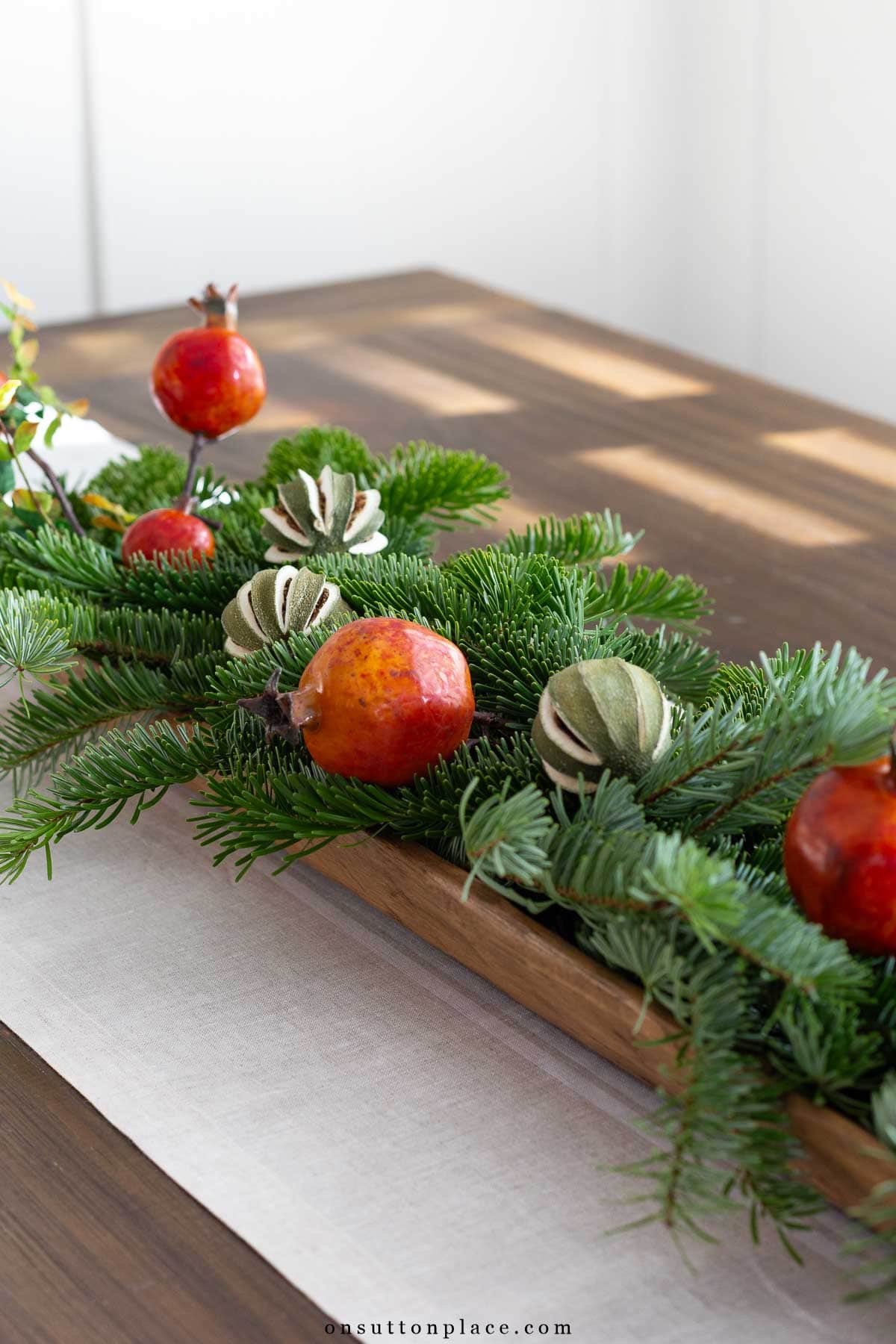 table with Christmas centerpiece in long dough bowl