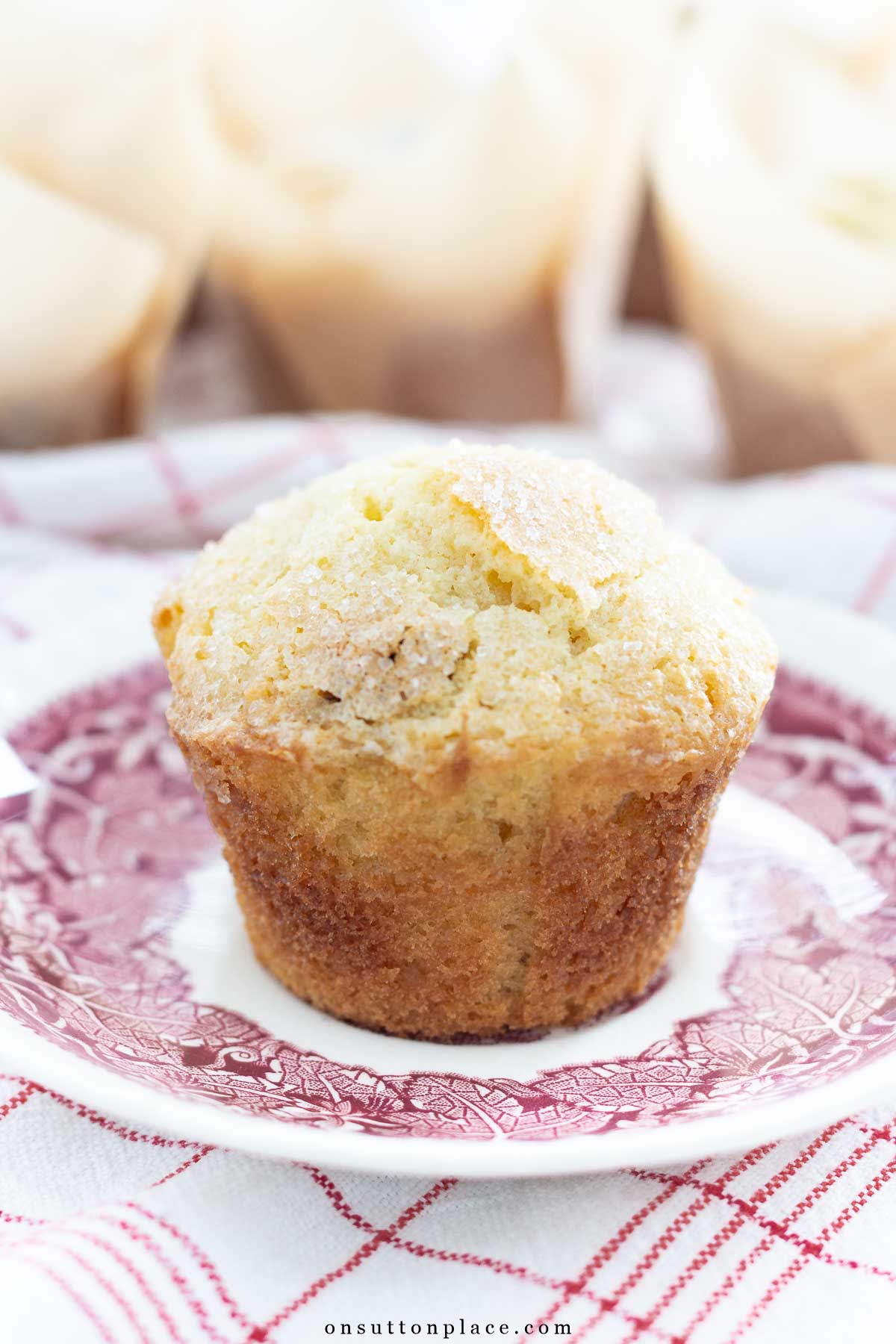 cherry muffin on plate with red plaid towel