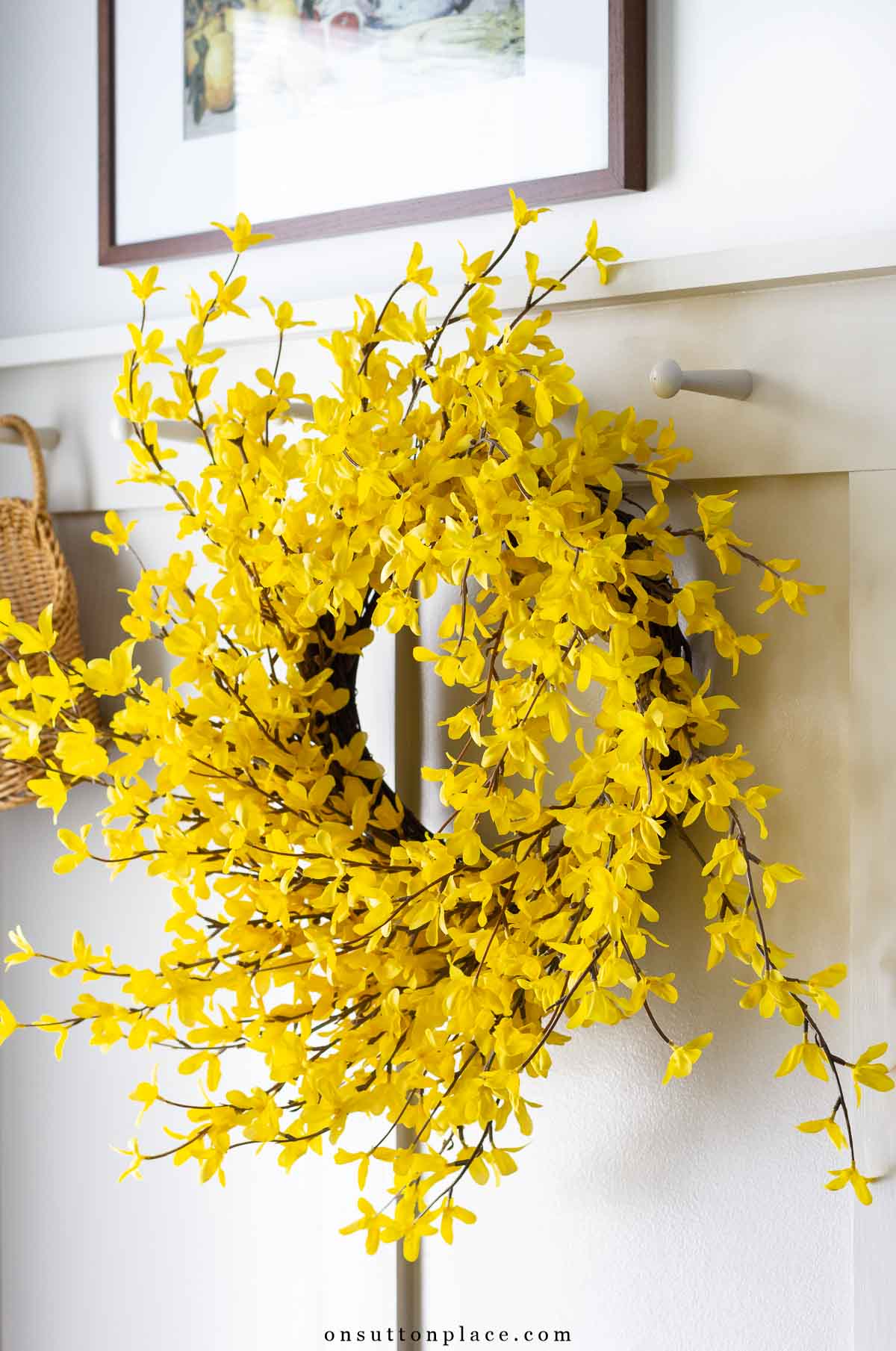 spring forsythia wreath on shaker pegs