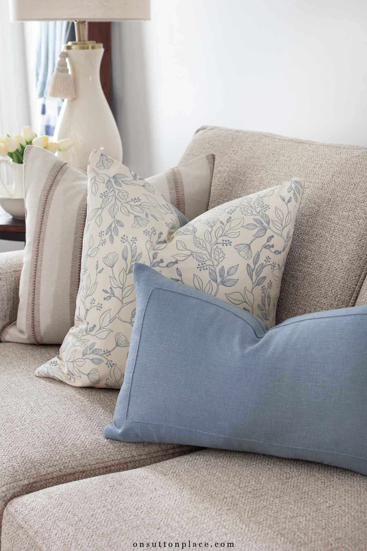 asymmetrical mismatched pillows on sofa different sizes