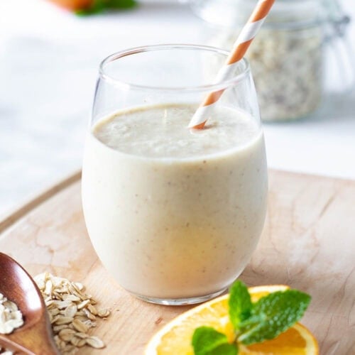 citrus smoothie recipe in glass with orange white straw