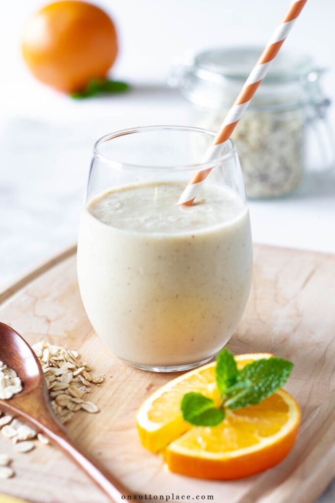 citrus smoothie recipe in glass with orange white straw