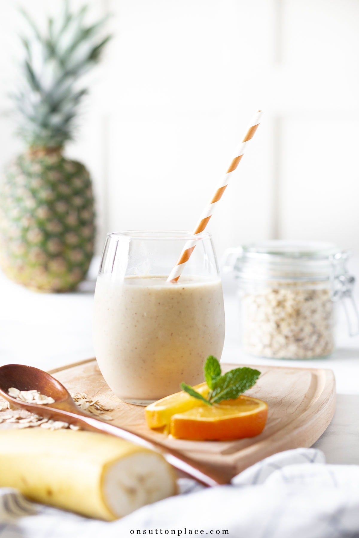 citrus smoothie recipe in glass with straw