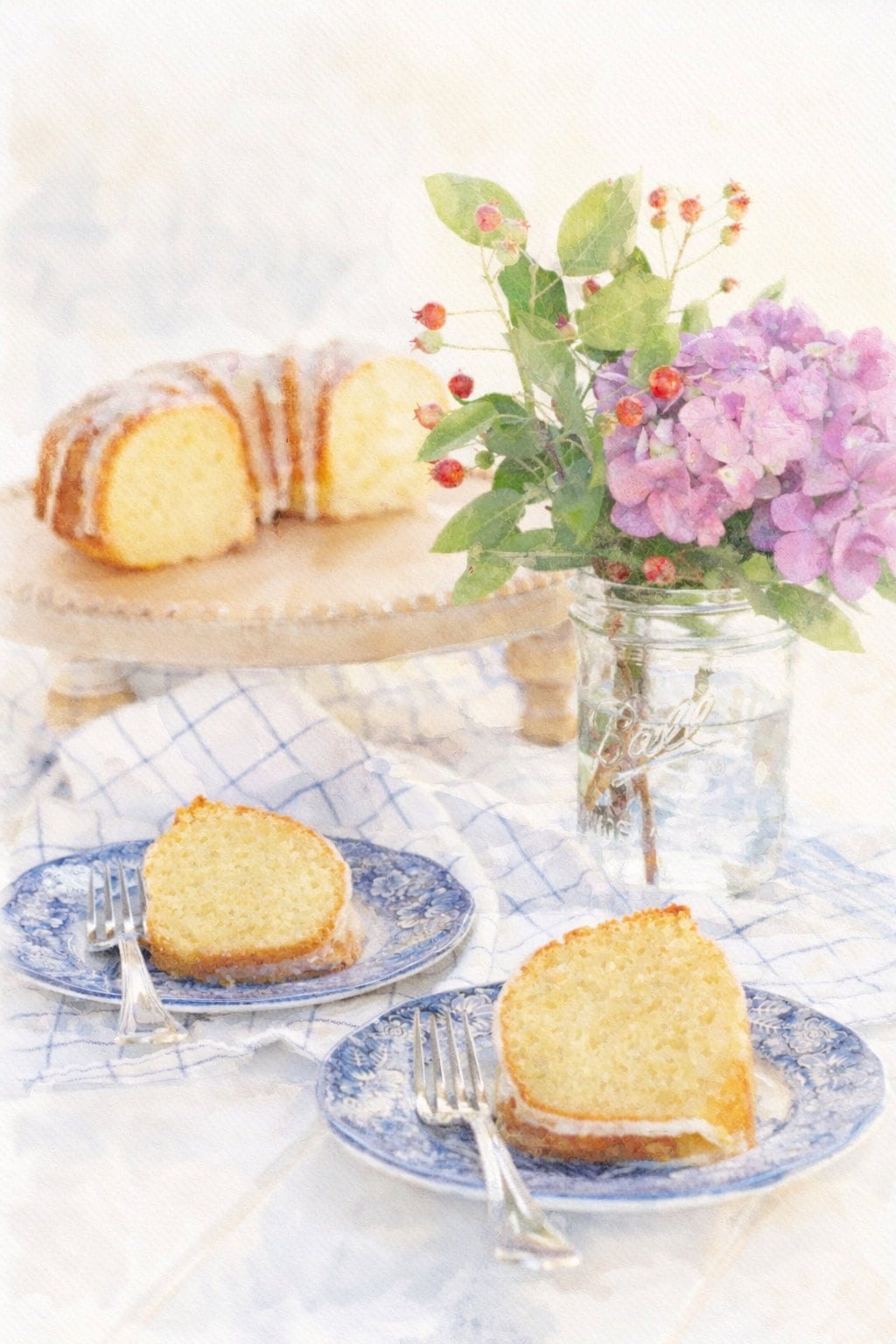 lemon bundt cake slices on blue plates with hydrangeas in mason jar watercolor