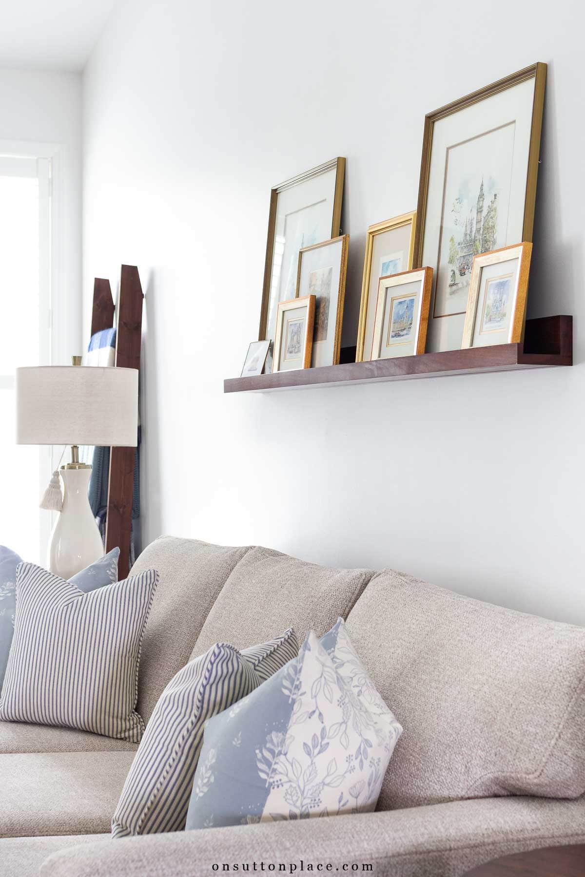 picture ledge over sofa with framed prints sherwin williams snowbound