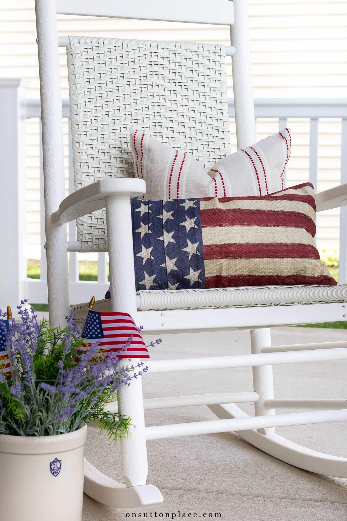 red white blue pillows on white porch rocker