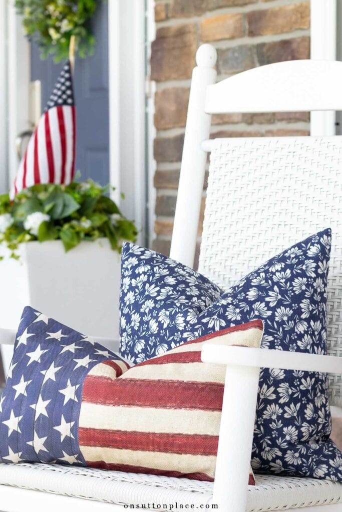 blue floral pillow with flag pillow on rocker