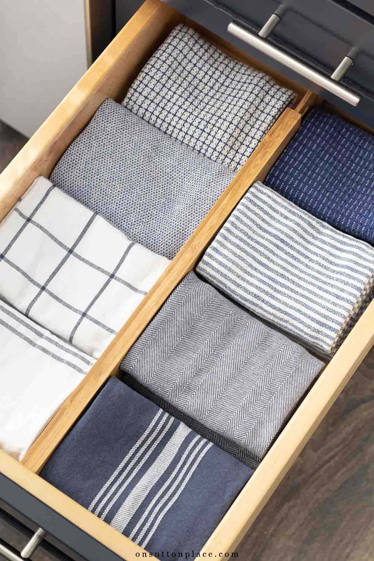 kitchen drawer organization blue tea towels folded