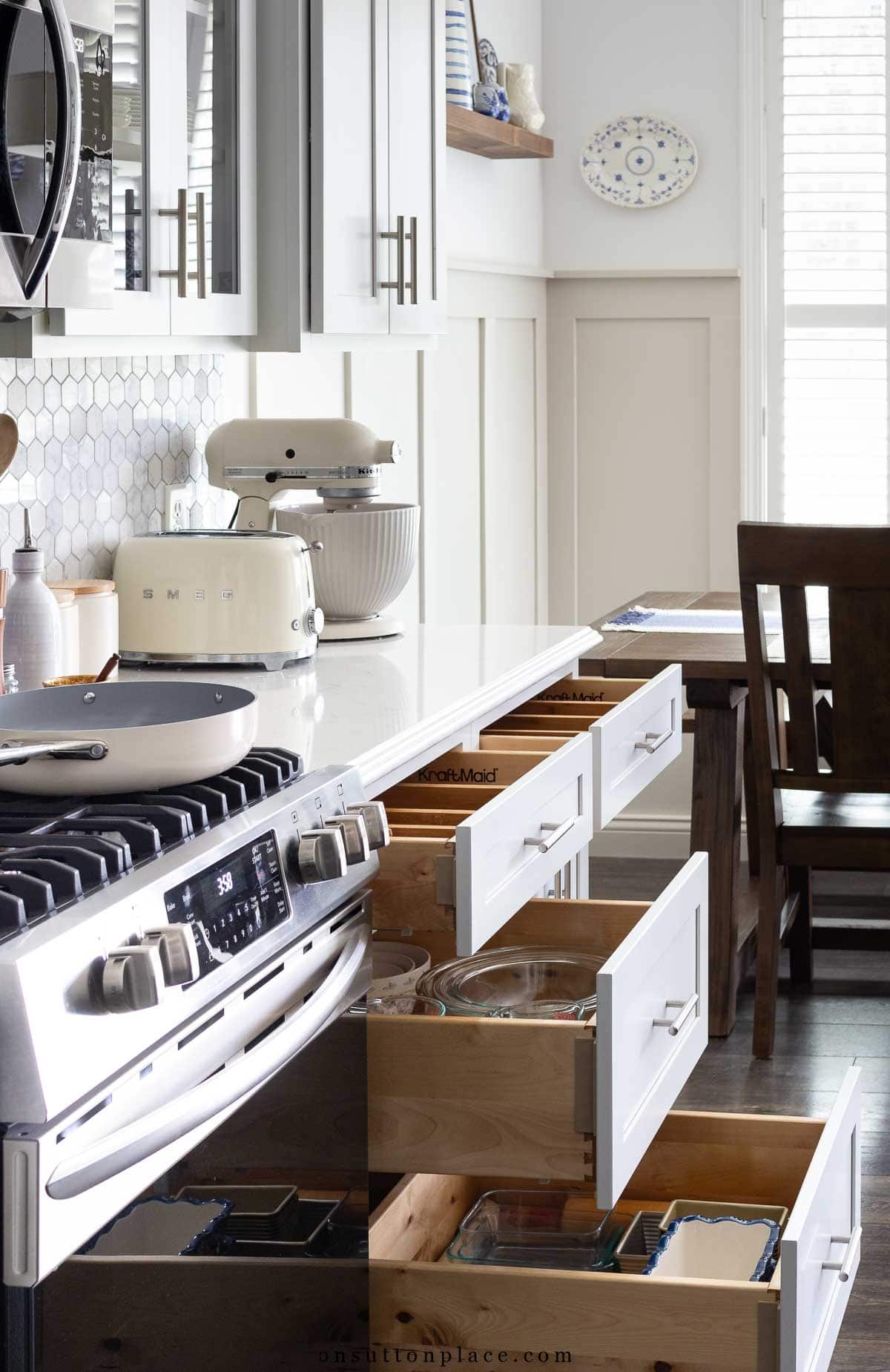 open drawers along wall work space in white kitchen