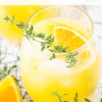 orange thyme spritzer mocktail tall pin