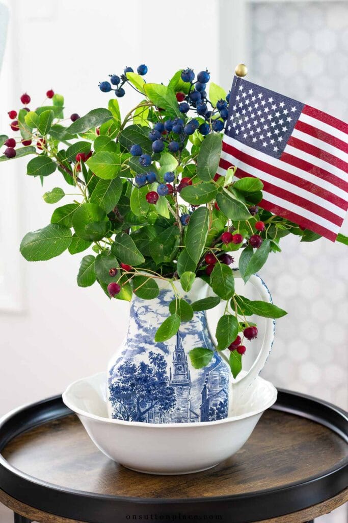 patriotic decor mini flag in pitcher of berries