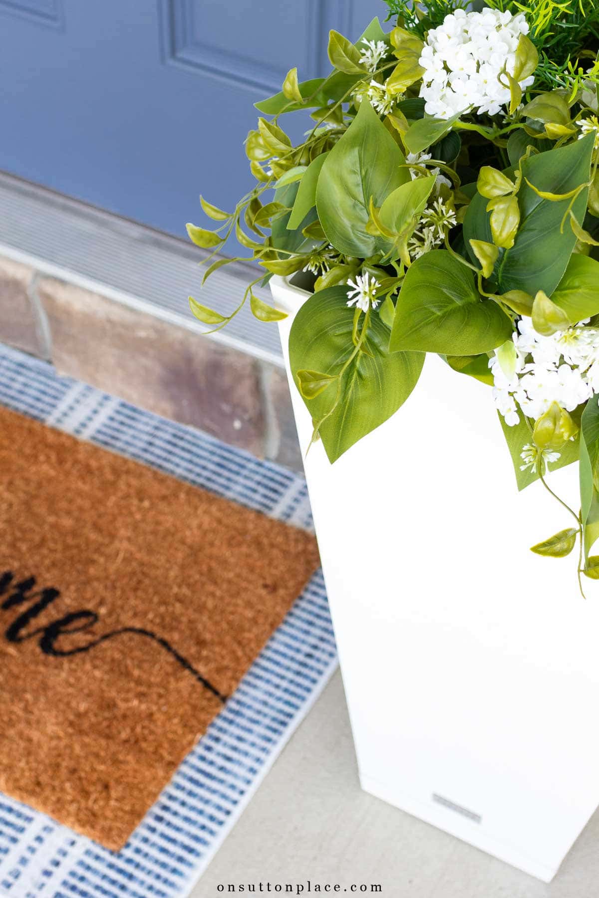 summer front porch flower pot with layered doormats